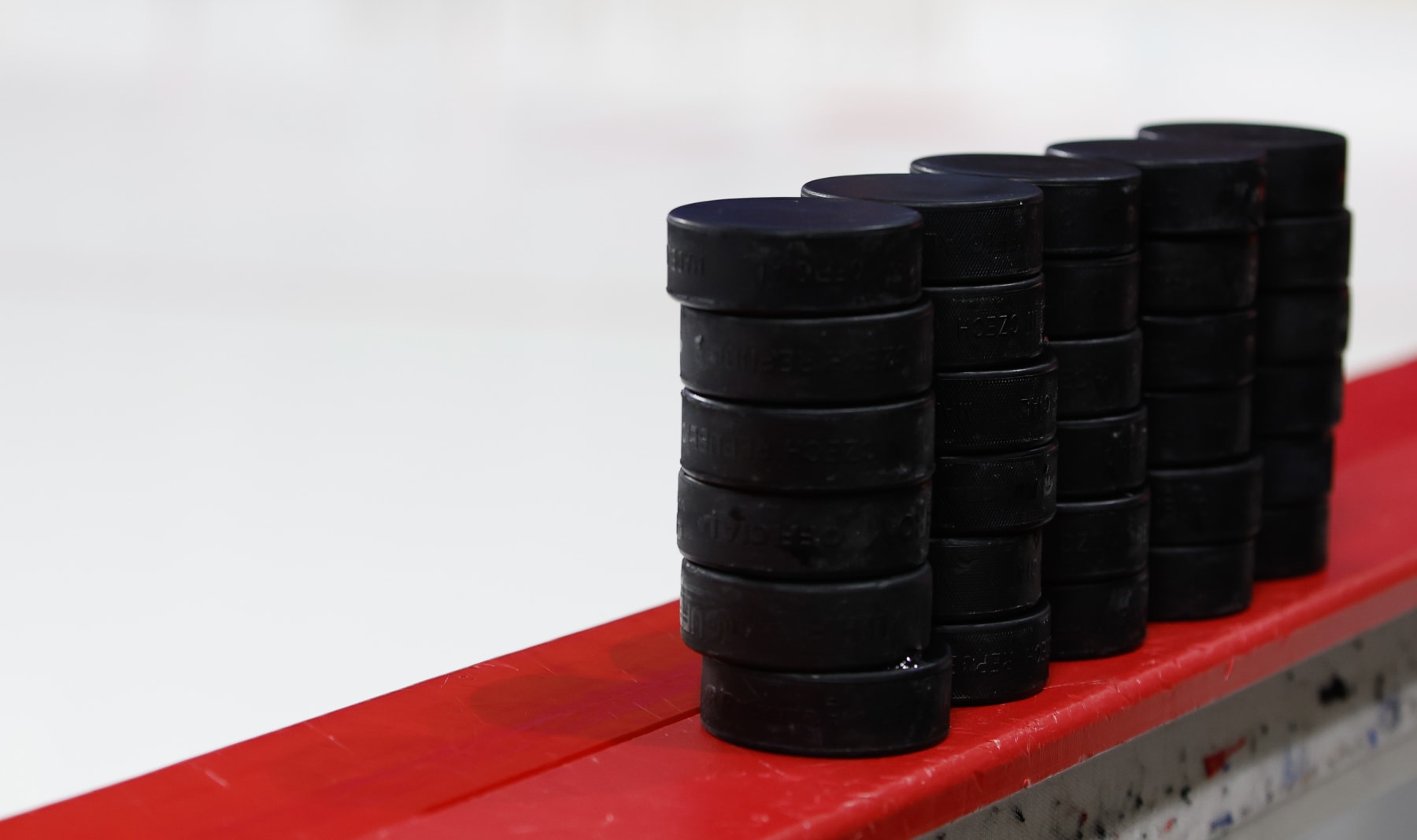 CHESTNUT HILL, MA - DECEMBER 2: A generic view of stacks of pucks on the bench before a game between the Boston College Eagles and the Providence College Friars NCAA hockey at Kelley Rink on December 2, 2022 in Chestnut Hill, Massachusetts. The game ended in a 1-1 tie with the Friars winning in a shootout. (Photo by Richard T Gagnon/Getty Images)