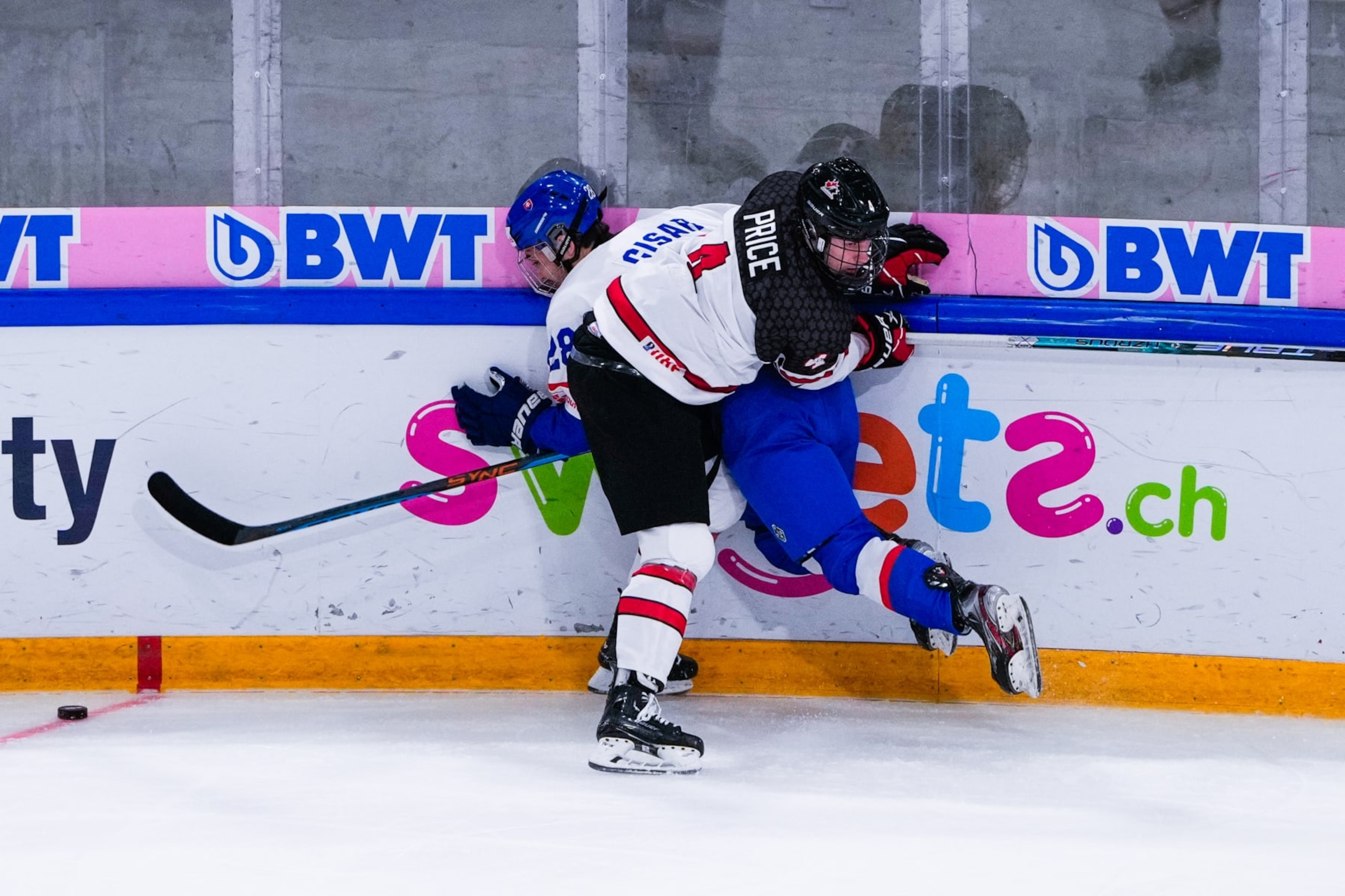 BASEL, SWITZERLAND - APRIL 30: Caden Price of Canada hit on Peter Cisar of Slovakia during U18 Ice Hockey World Championship bronze medal dispute match between Canada and Slovakia at St. Jakob-Park at St. Jakob-Park on April 30, 2023 in Basel, Switzerland. (Photo by Jari Pestelacci/Eurasia Sport Images/Getty Images)