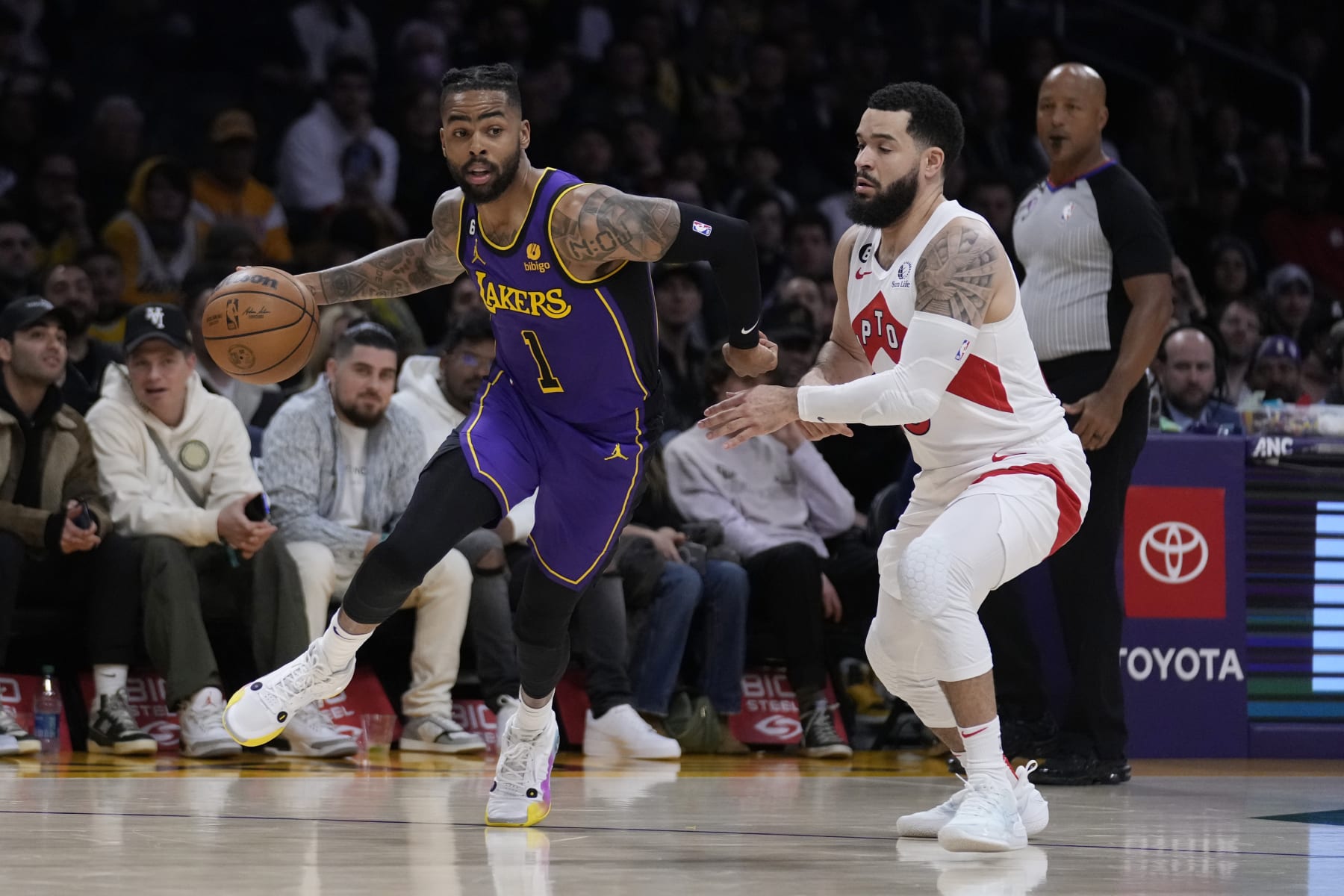 Los Angeles Lakers guard D'Angelo Russell, left, dribbles past Toronto Raptors guard Fred VanVleet during the first half of an NBA basketball game Friday, March 10, 2023, in Los Angeles. (AP Photo/Marcio Jose Sanchez)