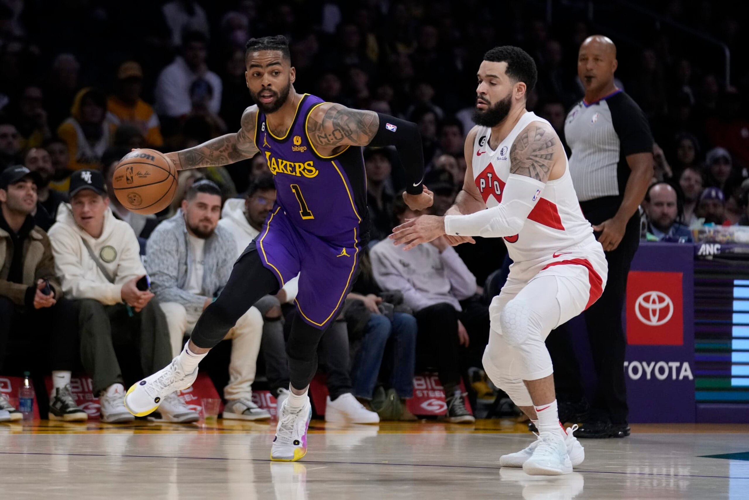 Los Angeles Lakers guard D'Angelo Russell, left, dribbles past Toronto Raptors guard Fred VanVleet during the first half of an NBA basketball game Friday, March 10, 2023, in Los Angeles. (AP Photo/Marcio Jose Sanchez)