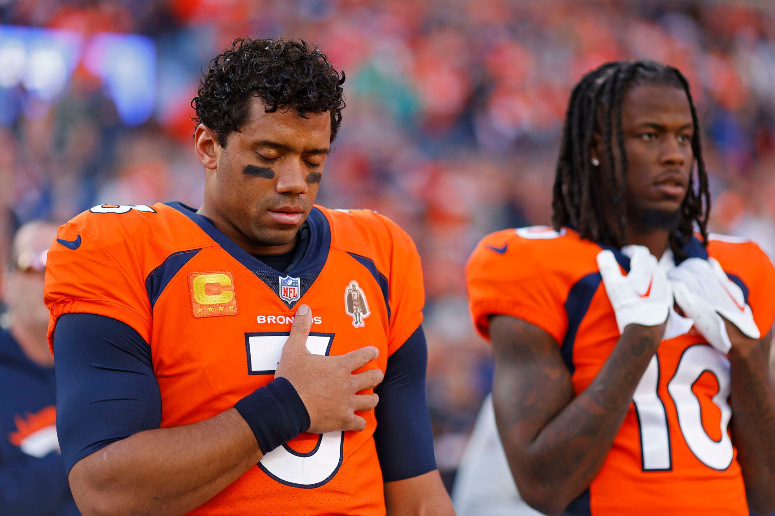 DENVER, COLORADO - JANUARY 08: Russell Wilson #3 of the Denver Broncos and Jerry Jeudy #10 of the Denver Broncos during the National Anthem prior to their game against the Los Angeles Chargers at Empower Field At Mile High on January 08, 2023 in Denver, Colorado. (Photo by Justin Edmonds/Getty Images)