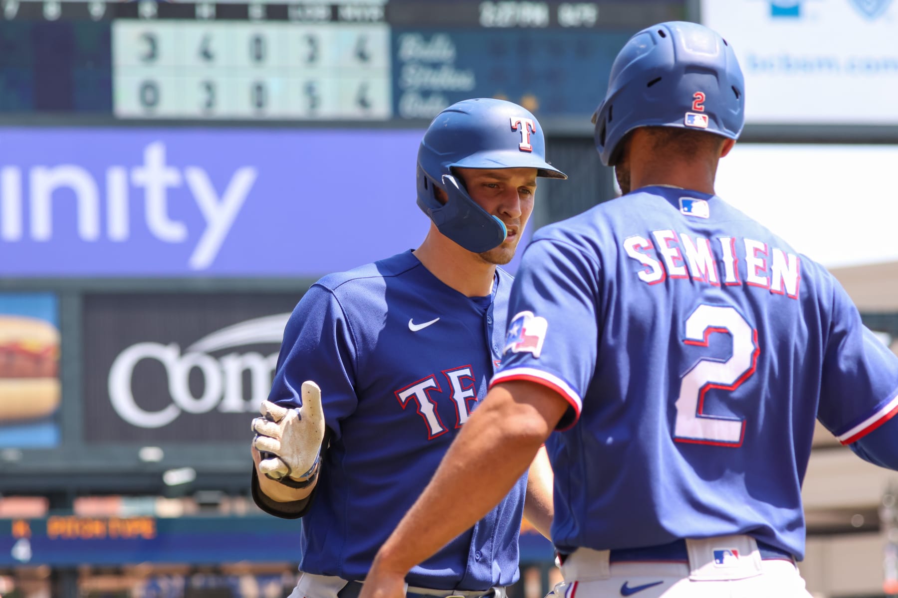 DETROIT, MI - MAY 29:  Texas Rangers shortstop Corey Seager (5), left, is congratulated by Texas Rangers second baseman Marcus Semien (2), right, after scoring a run during a regular season Major League Baseball game between the Texas Rangers and the Detroit Tigers on May 29, 2023 at Comerica Park in Detroit, Michigan.  (Photo by Scott W. Grau/Icon Sportswire via Getty Images)