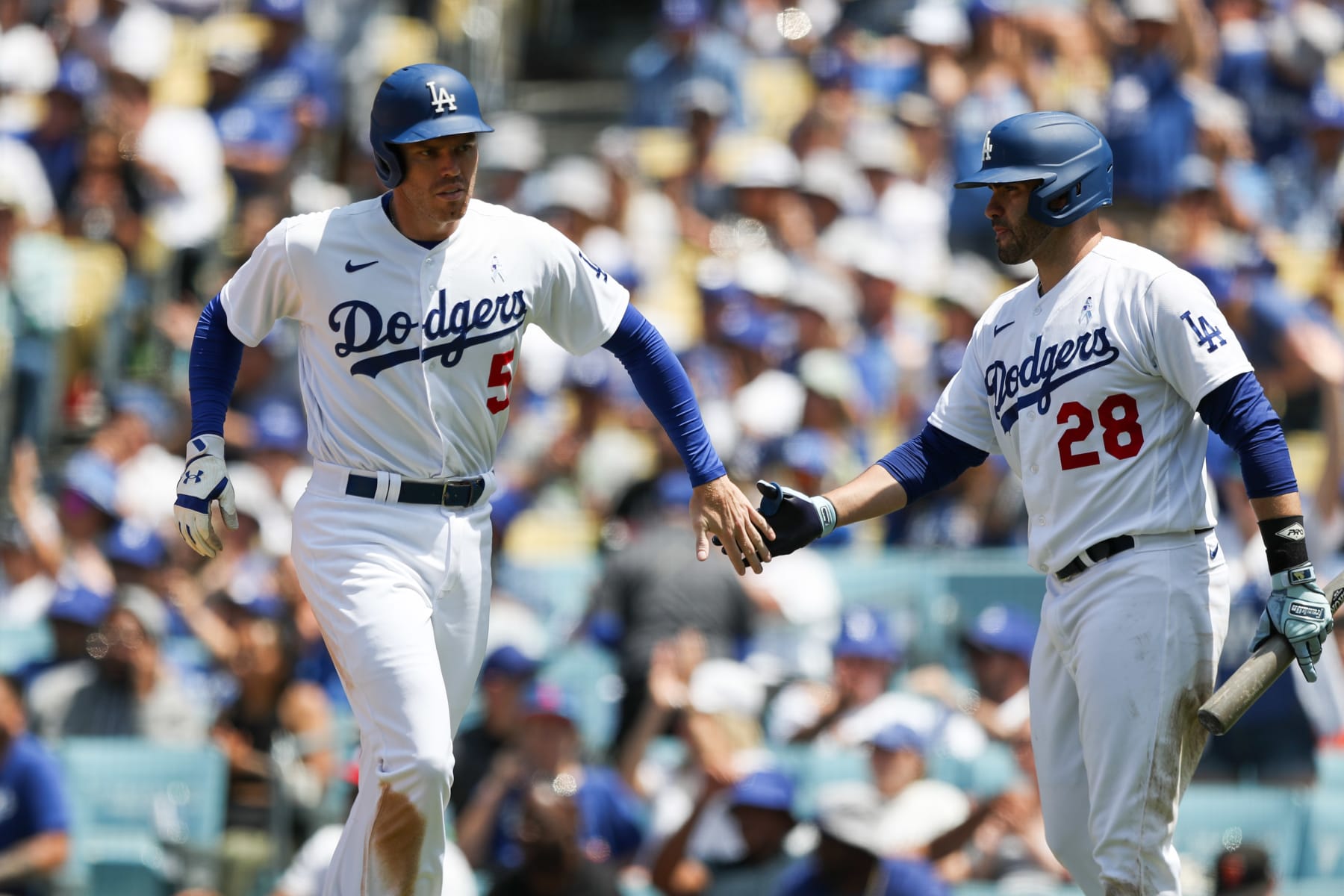LOS ANGELES, CA - JUNE 18:   Freddie Freeman #5 of the Los Angeles Dodgers high-fives J.D. Martinez #28 after scoring in the fifth inning during the game between the San Francisco Giants and the Los Angeles Dodgers at Dodger Stadium on Sunday, June 18, 2023 in Los Angeles, California. (Photo by Meg Oliphant/MLB Photos via Getty Images)