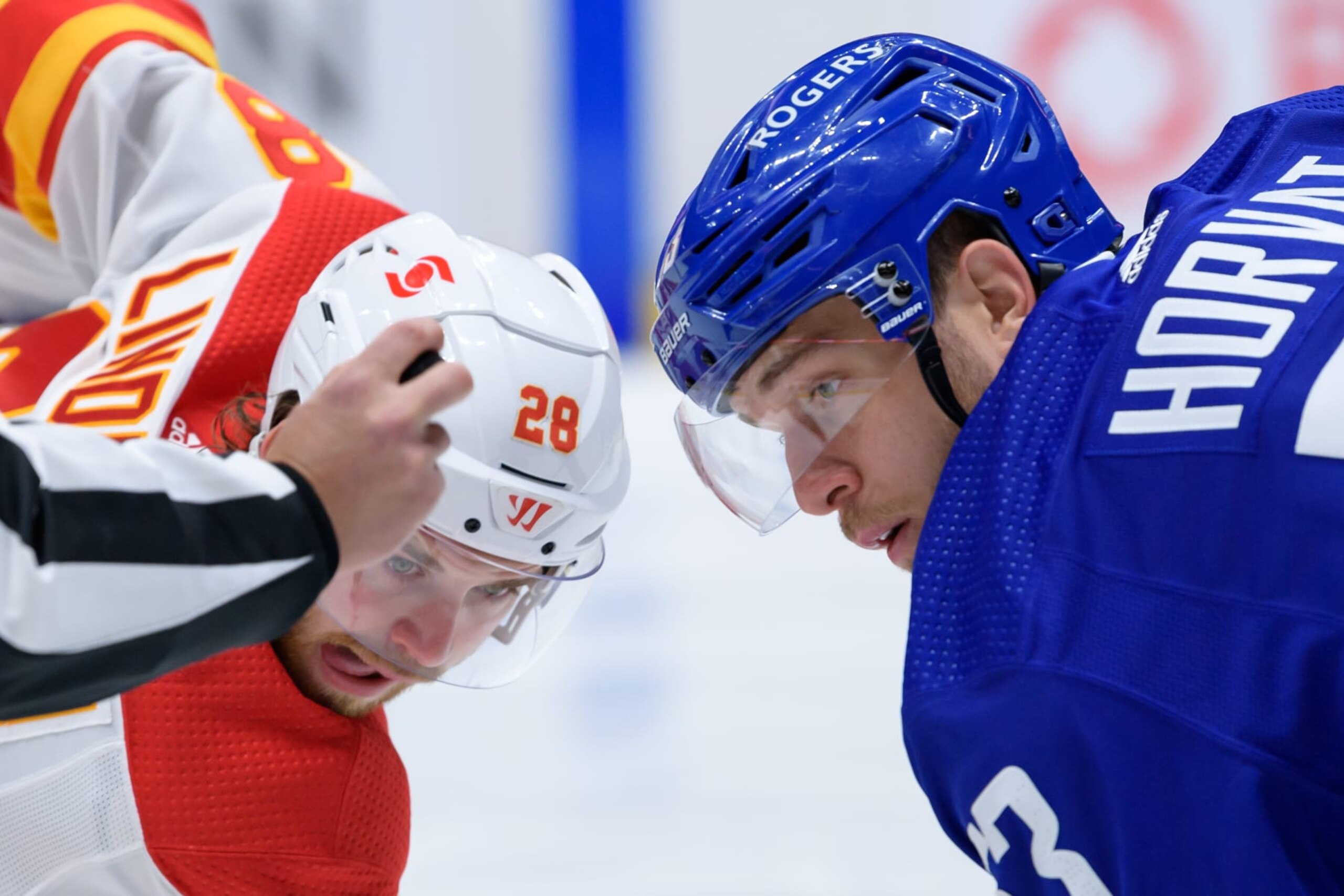 VANCOUVER, BC - MAY 16:  Vancouver Canucks center Bo Horvat (53) faces off against Calgary Flames center Elias Lindholm (28) during their NHL game at Rogers Arena on May 16, 2021 in Vancouver, British Columbia, Canada. (Photo by Derek Cain/Icon Sportswire via Getty Images)