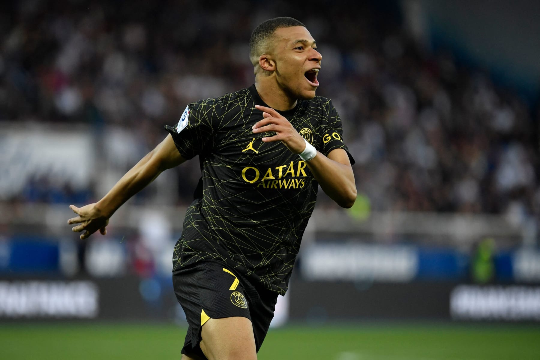 Paris Saint-Germain's French forward Kylian Mbappe celebrates after scoring a goal during the French L1 football match between AJ Auxerre and Paris Saint-Germain (PSG) at Stade de l'Abbe-Deschamps in Auxerre, central France, on May 21, 2023. (Photo by JULIEN DE ROSA / AFP) (Photo by JULIEN DE ROSA/AFP via Getty Images)