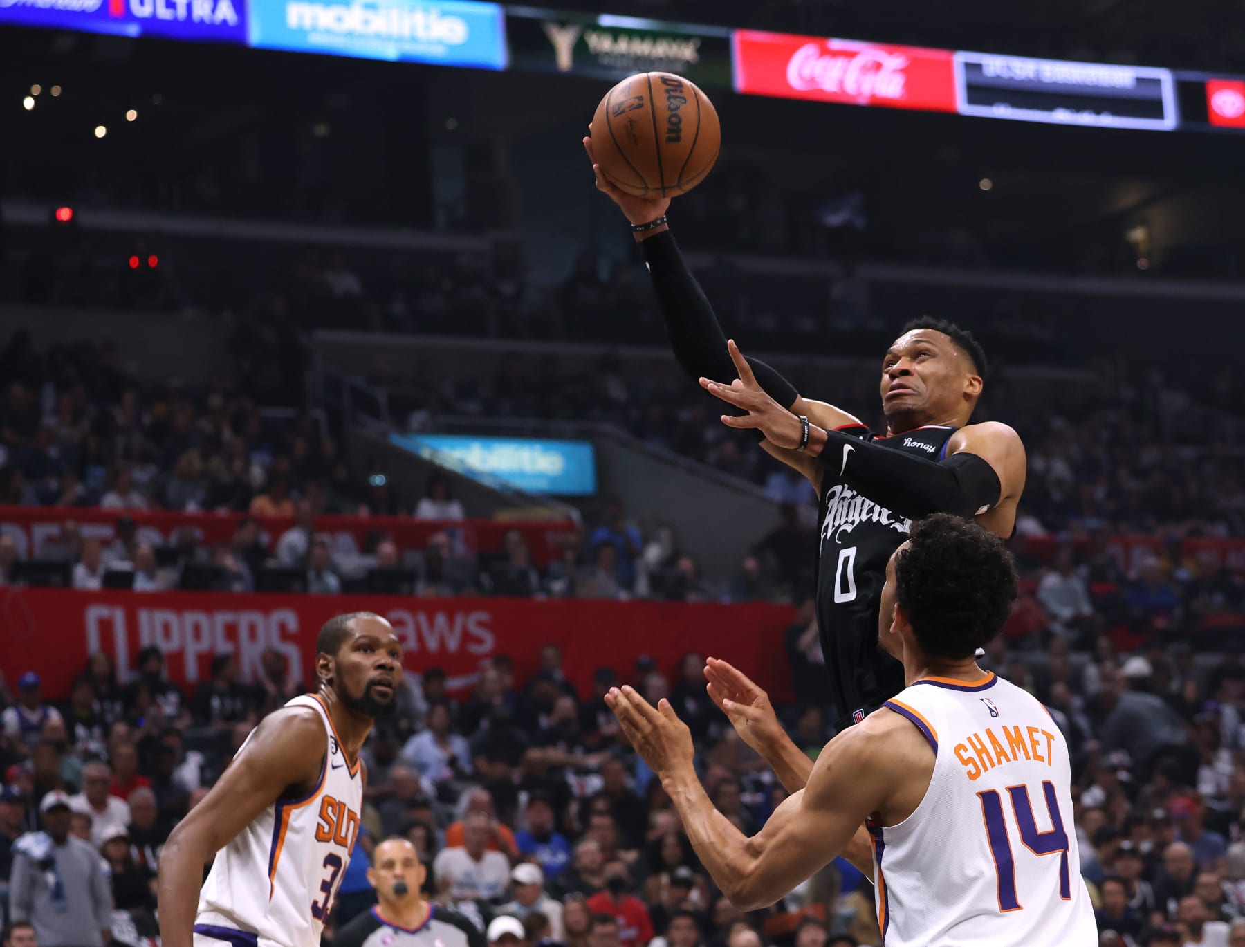 LOS ANGELES, CALIFORNIA - APRIL 22: Russell Westbrook #0 of the LA Clippers scores on a layup in front of Landry Shamet #14 and Kevin Durant #35 of the Phoenix Suns during the first quarter of Game Four of the Western Conference First Round Playoffs at Crypto.com Arena on April 22, 2023 in Los Angeles, California. NOTE TO USER: User expressly acknowledges and agrees that, by downloading and or using this photograph, User is consenting to the terms and conditions of the Getty Images License Agreement. (Photo by Harry How/Getty Images)