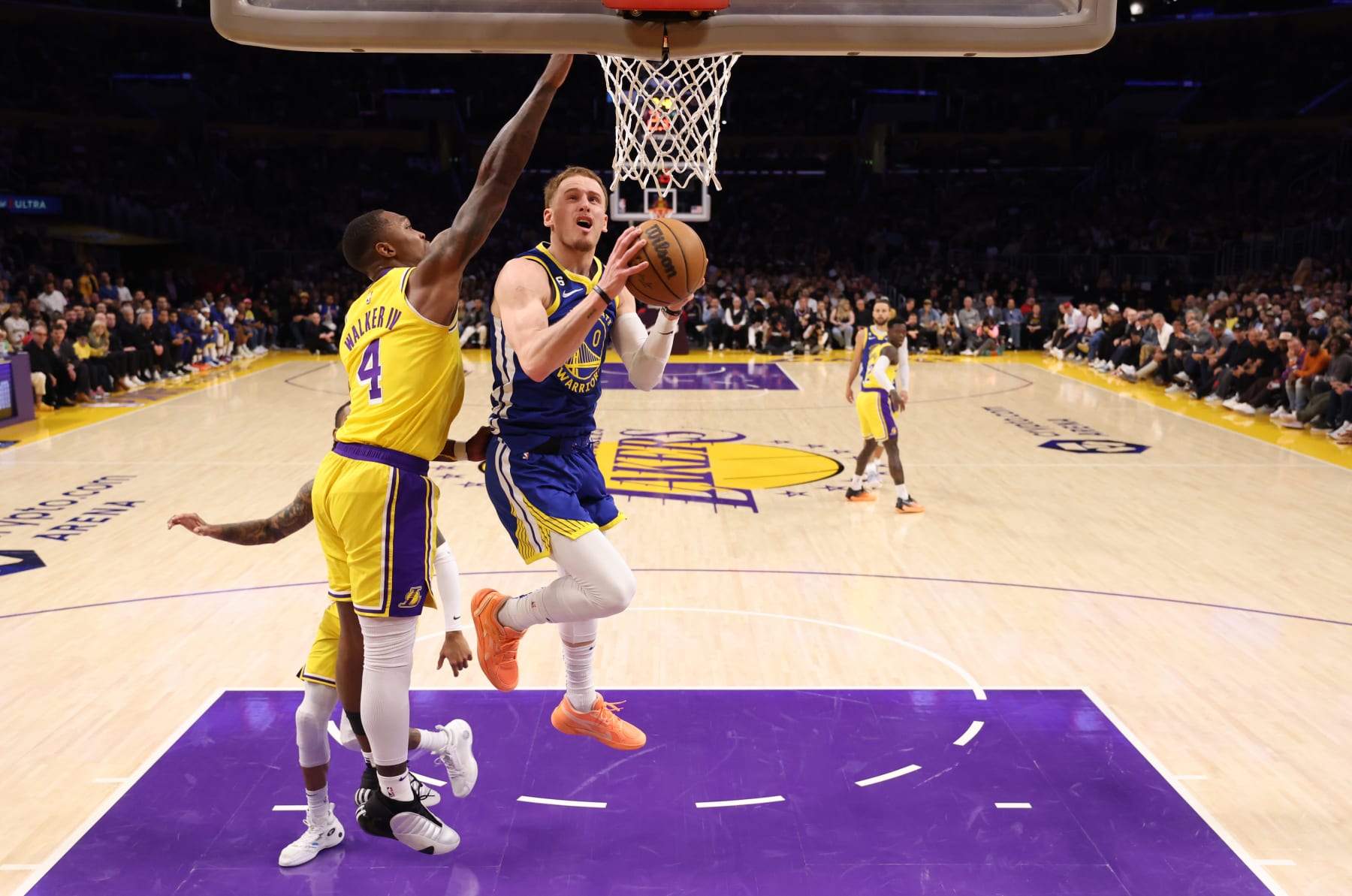 LOS ANGELES, CALIFORNIA - MAY 12: Donte DiVincenzo #0 of the Golden State Warriors attempts a layup against Lonnie Walker IV #4 of the Los Angeles Lakers during the second quarter in game six of the Western Conference Semifinal Playoffs at Crypto.com Arena on May 12, 2023 in Los Angeles, California. NOTE TO USER: User expressly acknowledges and agrees that, by downloading and or using this photograph, User is consenting to the terms and conditions of the Getty Images License Agreement. (Photo by Harry How/Getty Images)