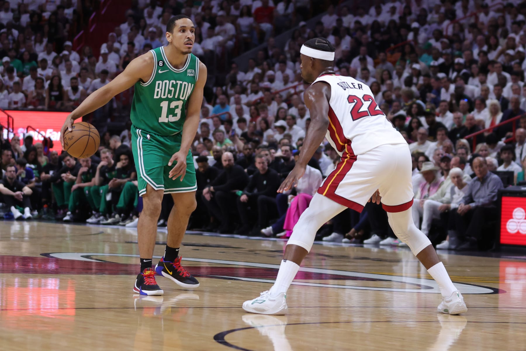 MIAMI, FLORIDA - MAY 23: Malcolm Brogdon #13 of the Boston Celtics controls the ball against Jimmy Butler #22 of the Miami Heat during the first quarter in game four of the Eastern Conference Finals at Kaseya Center on May 23, 2023 in Miami, Florida. NOTE TO USER: User expressly acknowledges and agrees that, by downloading and or using this photograph, User is consenting to the terms and conditions of the Getty Images License Agreement. (Photo by Megan Briggs/Getty Images)