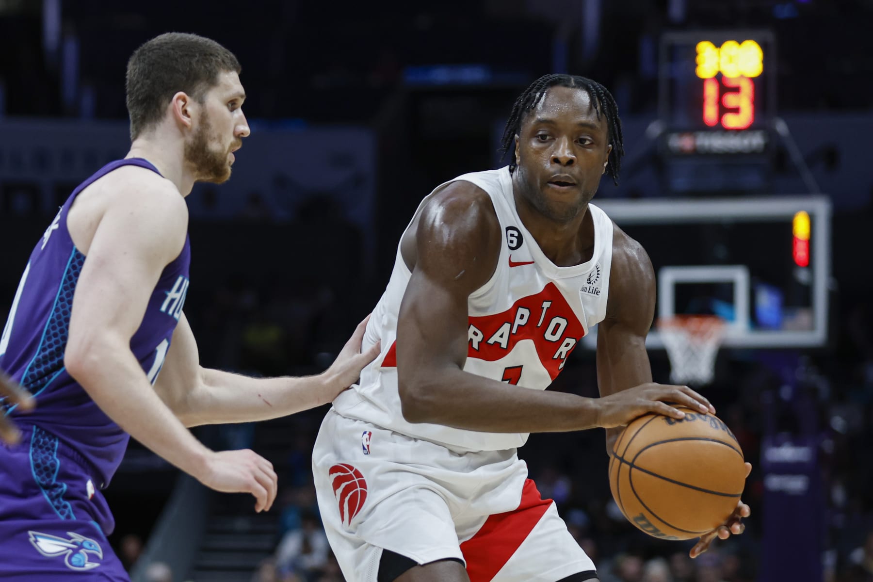 Toronto Raptors forward O.G. Anunoby, right, passes against Charlotte Hornets guard Svi Mykhailiuk during the second half of an NBA basketball game in Charlotte, N.C., Sunday, April 2, 2023. Toronto won 128-108. (AP Photo/Nell Redmond)