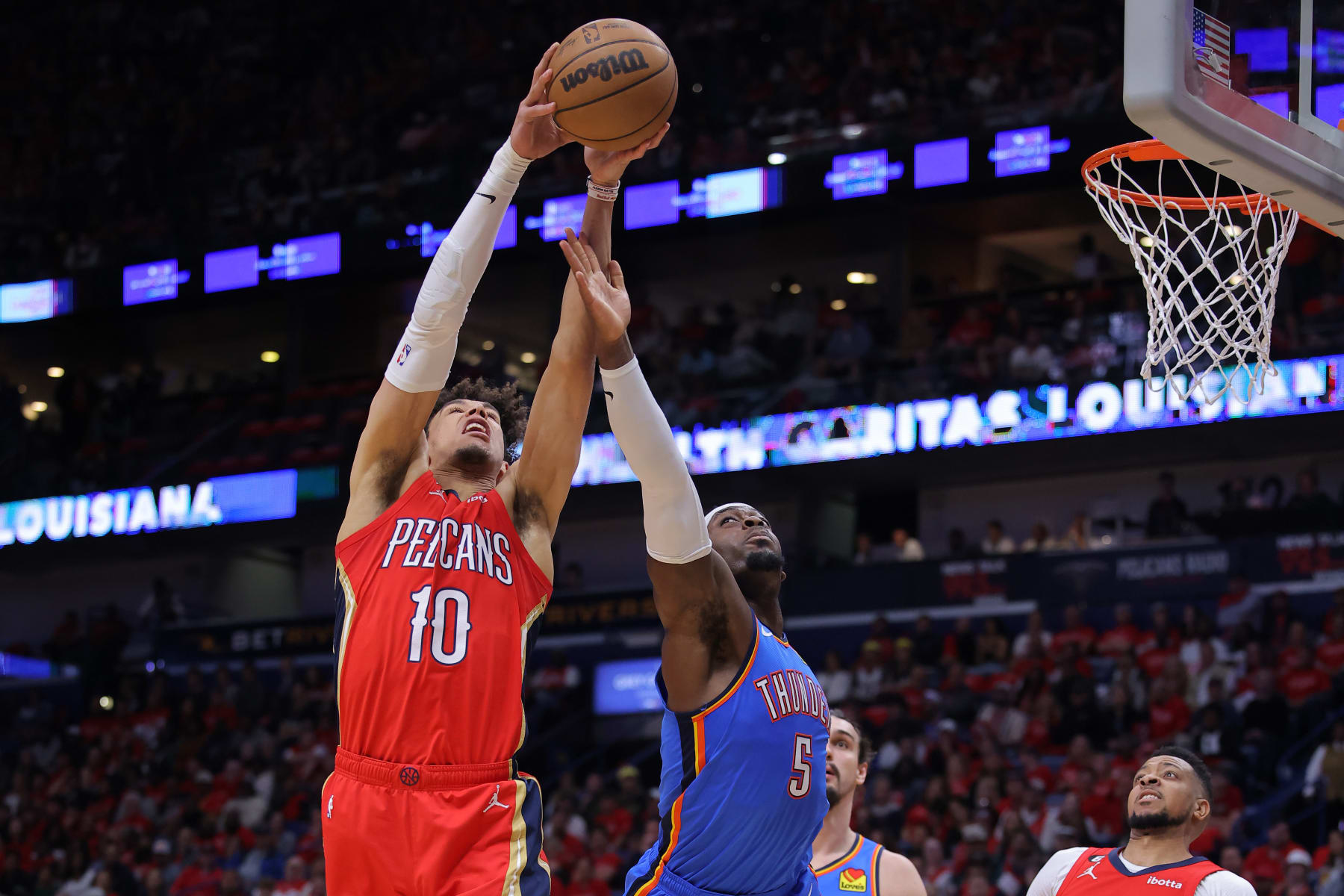NEW ORLEANS, LOUISIANA - APRIL 12: Jaxson Hayes #10 of the New Orleans Pelicans and Luguentz Dort #5 of the Oklahoma City Thunder go for a rebound during the first half at the Smoothie King Center on April 12, 2023 in New Orleans, Louisiana. NOTE TO USER: User expressly acknowledges and agrees that, by downloading and or using this Photograph, user is consenting to the terms and conditions of the Getty Images License Agreement. (Photo by Jonathan Bachman/Getty Images)