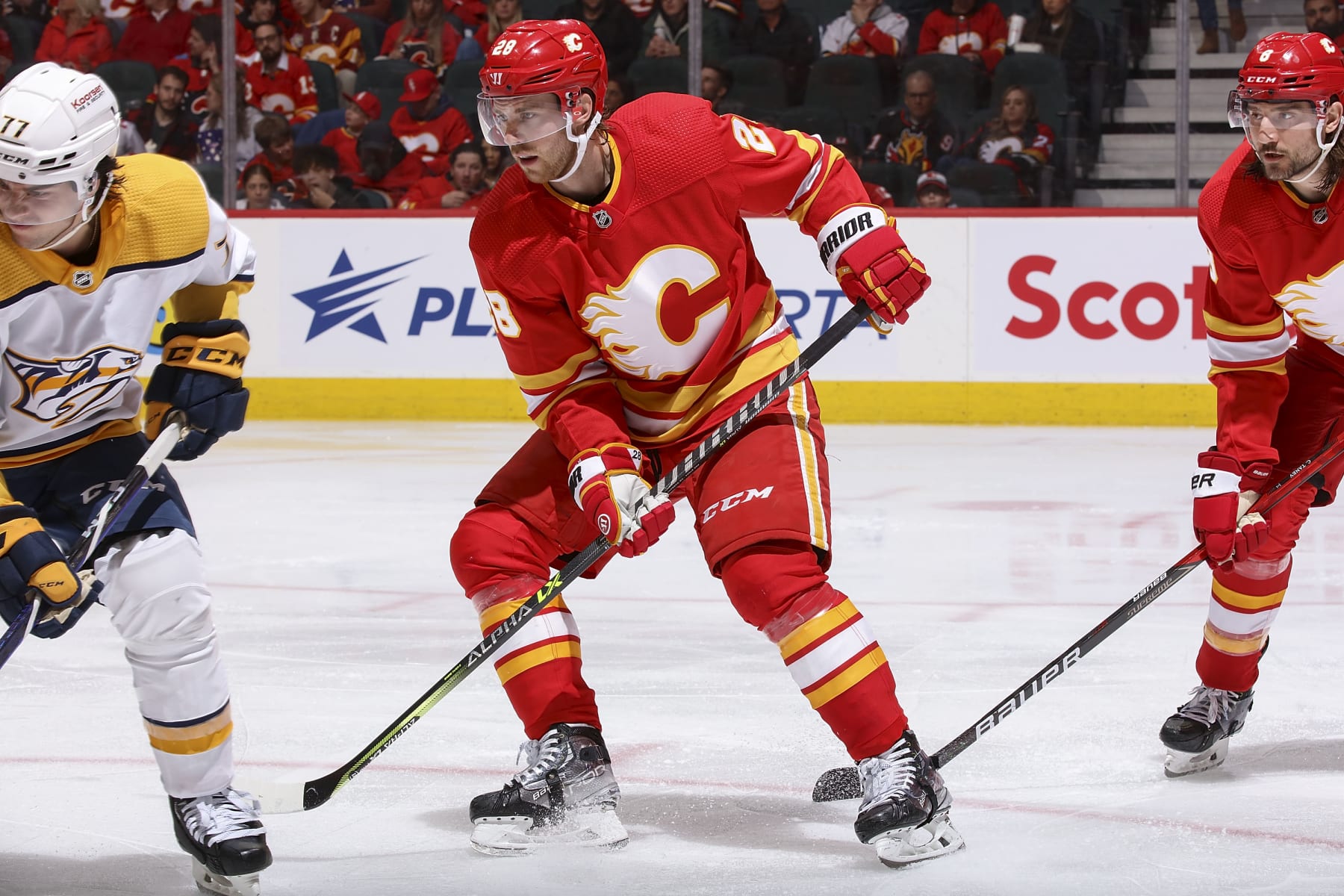 CALGARY, AB - APRIL 10: Elias Lindholm #28 of the Calgary Flames battles against the Nashville Predators at Scotiabank Saddledome on April 10, 2023 in Calgary, Alberta, Canada. (Photo by Gerry Thomas/NHLI via Getty Images)