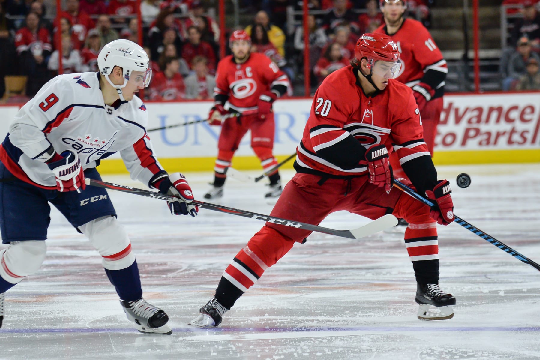 RALEIGH, NC - JANUARY 12: Carolina Hurricanes Left Wing Sebastian Aho (20) attempts to play a puck in mid-air in front of Washington Capitals Defenceman Dmitry Orlov (9) during a game between the Washington Capitals and the Carolina Hurricanes at the PNC Arena in Raleigh, NC on January 12, 2018. Washington defeated Carolina 4-3. (Photo by Greg Thompson/Icon Sportswire via Getty Images) RALEIGH, NC - JANUARY 12: Carolina Hurricanes Left Wing Sebastian Aho (20) attempts to play a puck in mid-air in front of Washington Capitals Defenceman Dmitry Orlov (9) during a game between the Washington Capitals and the Carolina Hurricanes at the PNC Arena in Raleigh, NC on January 12, 2018. Washington defeated Carolina 4-3. (Photo by Greg Thompson/Icon Sportswire via Getty Images)