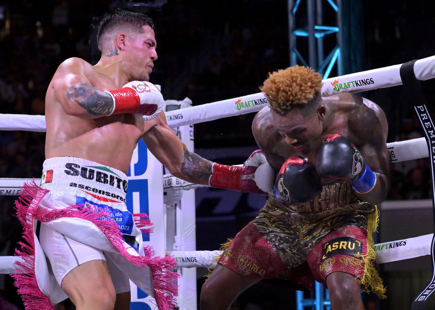 CARSON, CA - MAY 14: Jermell Charlo (gold/red shorts) exchanges punches in the ring with Brian Castano (white/pink shorts) during their super middleweight title fight at Dignity Health Sports Park on May 14, 2022 in Carson, California. Charlo won by knockout in the 10th round. (Photo by Jayne Kamin-Oncea/Getty Images)