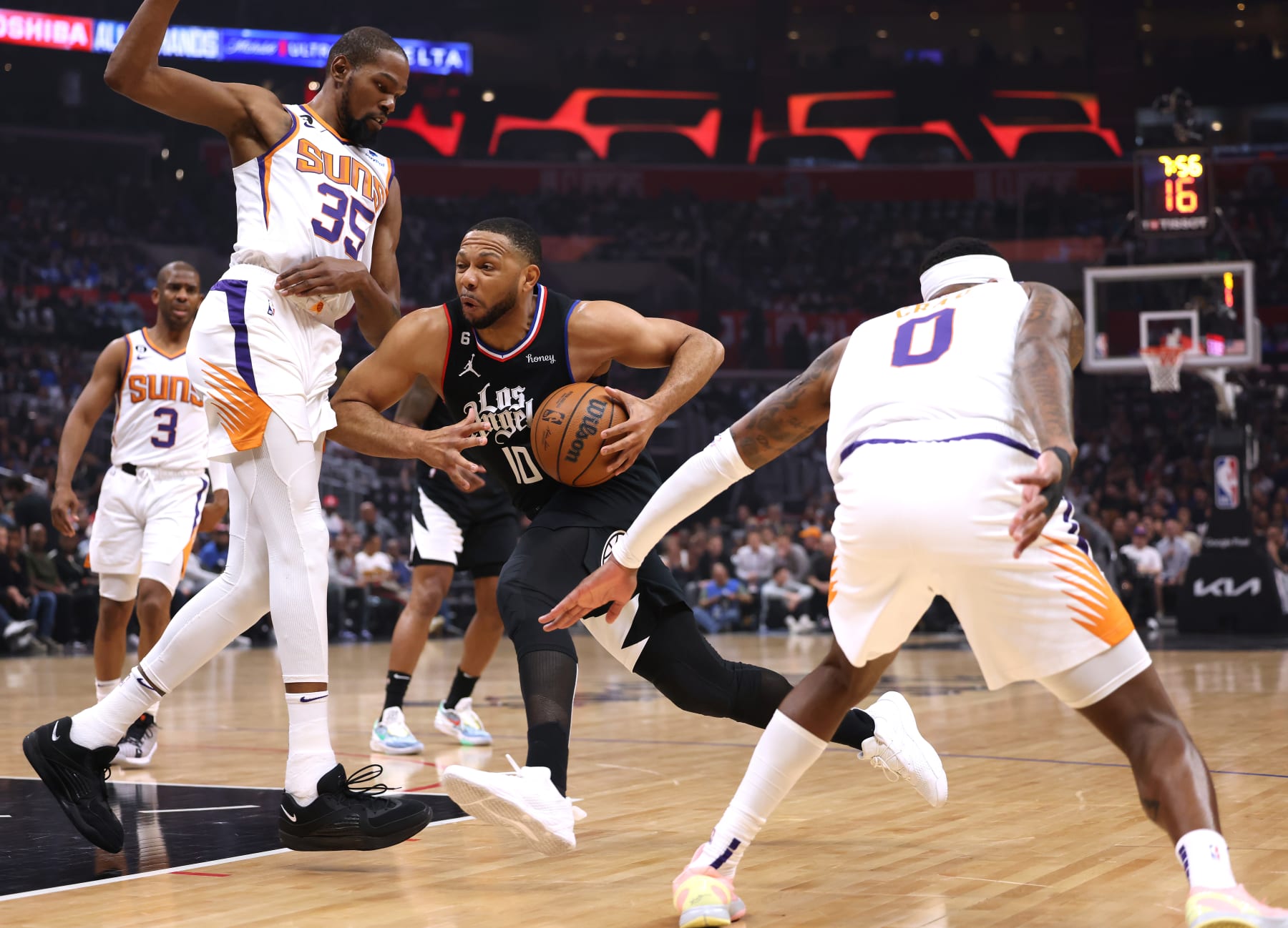 LOS ANGELES, CALIFORNIA - APRIL 22: Eric Gordon #10 of the LA Clippers drives to the basket between Kevin Durant #35 and Torrey Craig #0 of the Phoenix Suns during the first quarter of Game Four of the Western Conference First Round Playoffs at Crypto.com Arena on April 22, 2023 in Los Angeles, California. NOTE TO USER: User expressly acknowledges and agrees that, by downloading and or using this photograph, User is consenting to the terms and conditions of the Getty Images License Agreement. (Photo by Harry How/Getty Images)