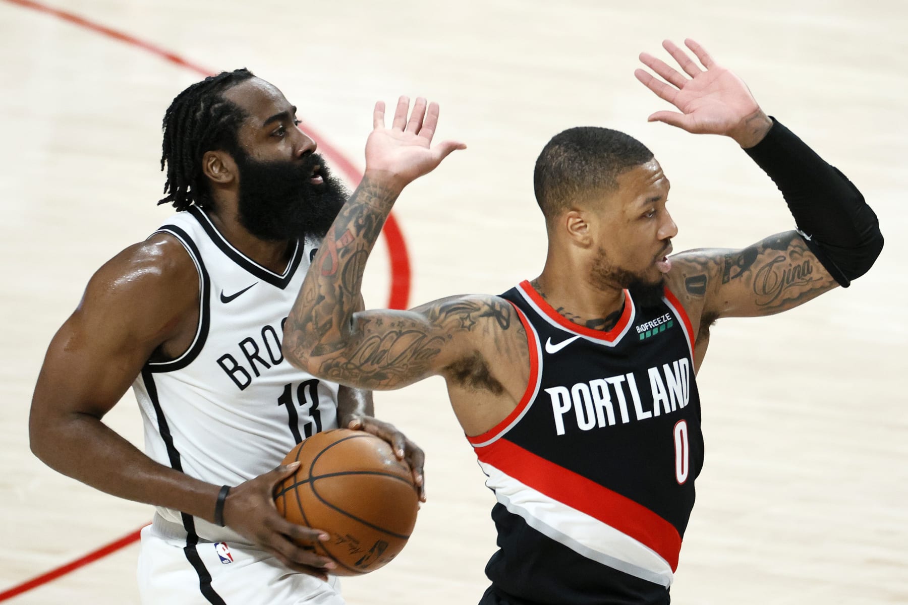 PORTLAND, OREGON - MARCH 23: James Harden #13 of the Brooklyn Nets looks to shoot while defended by Damian Lillard #0 of the Portland Trail Blazers during the second quarter at Moda Center on March 23, 2021 in Portland, Oregon. NOTE TO USER: User expressly acknowledges and agrees that, by downloading and or using this photograph, User is consenting to the terms and conditions of the Getty Images License Agreement. (Photo by Steph Chambers/Getty Images)