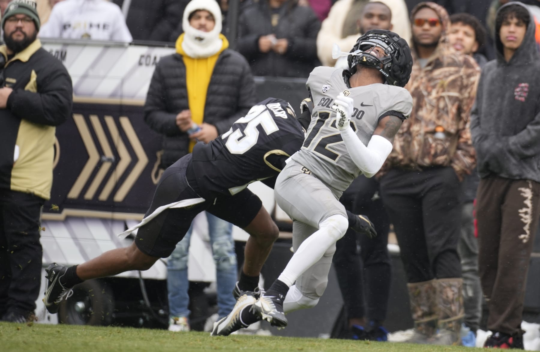 Colorado cornerback wide receiver Travis Hunter (12) and Colorado inside linebacker Marvin Ham II (25) in the first half of the team's spring practice NCAA college football game Saturday, April 22, 2023, in Boulder, Colo. (AP Photo/David Zalubowski)
