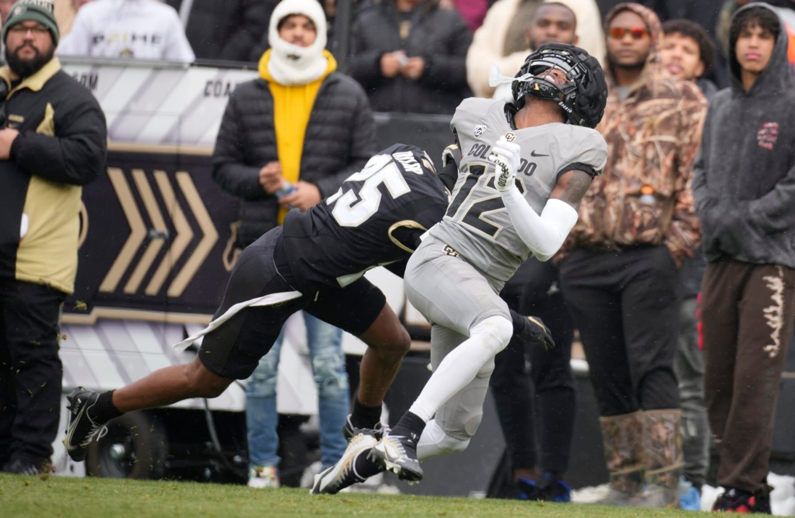Colorado cornerback wide receiver Travis Hunter (12) and Colorado inside linebacker Marvin Ham II (25) in the first half of the team's spring practice NCAA college football game Saturday, April 22, 2023, in Boulder, Colo. (AP Photo/David Zalubowski)