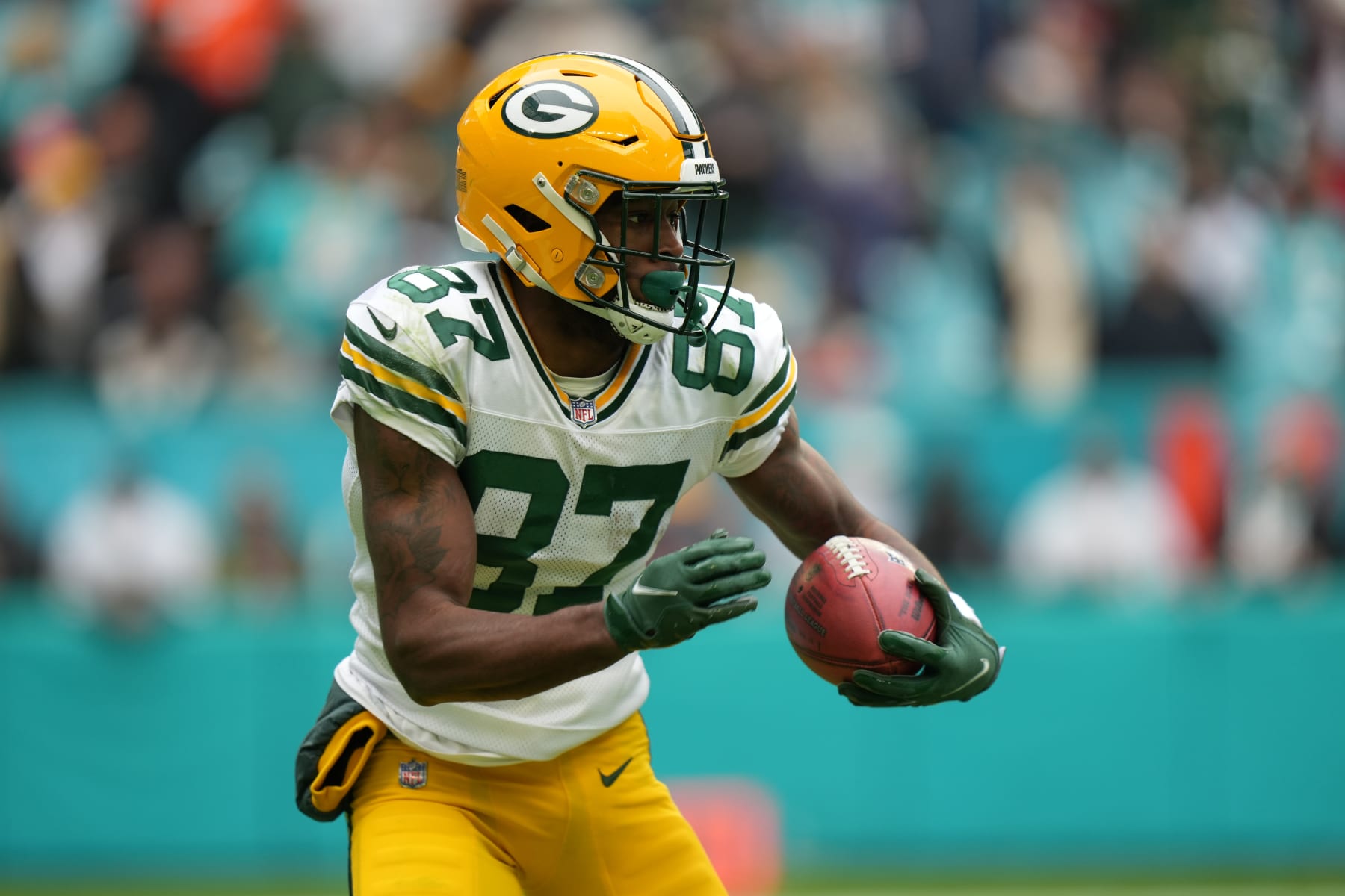 MIAMI GARDENS, FL - DECEMBER 25: Green Bay Packers wide receiver Romeo Doubs (87) returns a kick during the game between the Green Bay Packers and the Miami Dolphins on Sunday, December 25, 2022 at Hard Rock Stadium, Miami Gardens, Fla. (Photo by Peter Joneleit/Icon Sportswire via Getty Images)