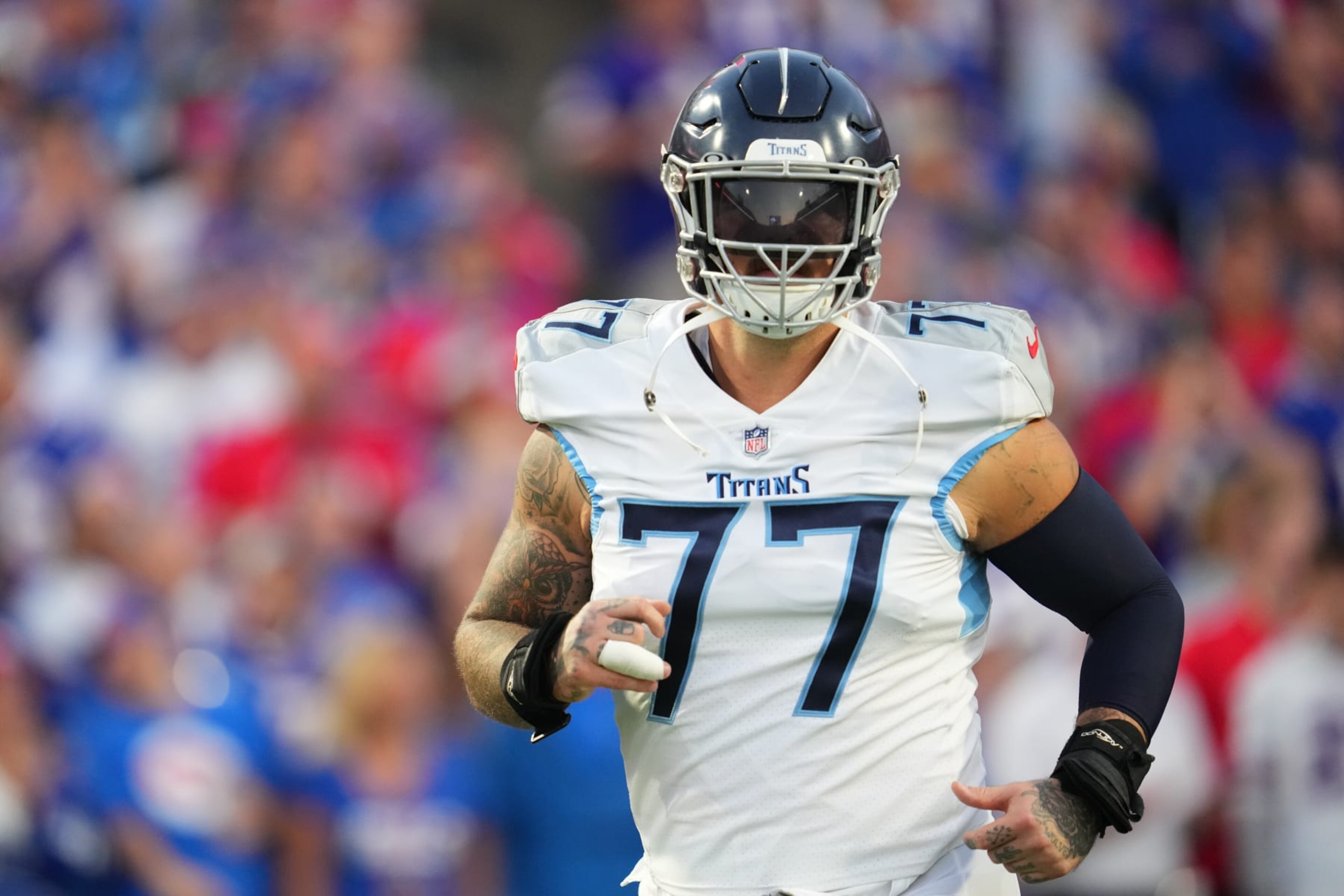 ORCHARD PARK, NY - SEPTEMBER 19: Taylor Lewan #77 of the Tennessee Titans runs onto the field against the Buffalo Bills at Highmark Stadium on September 19, 2022 in Orchard Park, New York. (Photo by Cooper Neill/Getty Images) ORCHARD PARK, NY - SEPTEMBER 19: Taylor Lewan #77 of the Tennessee Titans runs onto the field against the Buffalo Bills at Highmark Stadium on September 19, 2022 in Orchard Park, New York. (Photo by Cooper Neill/Getty Images)
