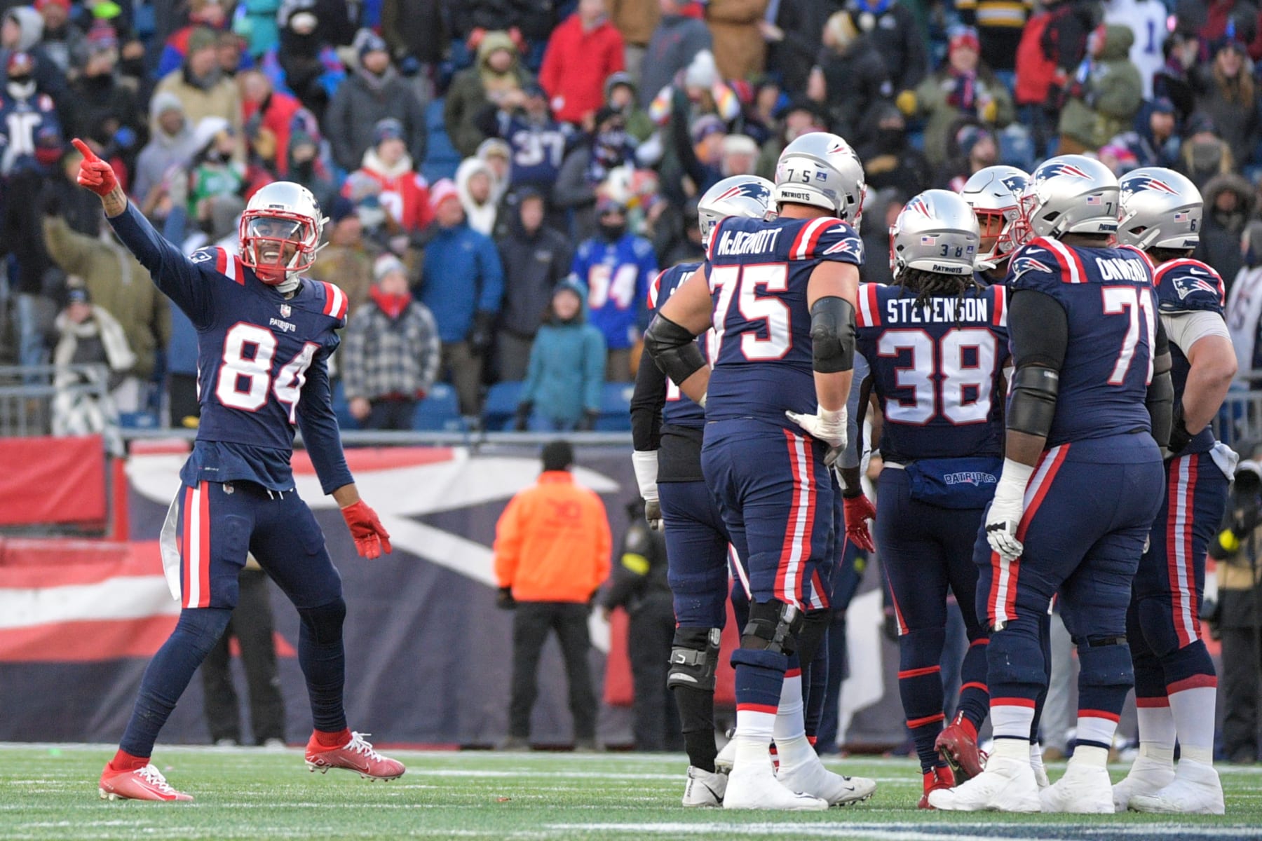 FOXBOROUGH, MA - DECEMBER 24: New England Patriots wide receiver Kendrick Bourne (84) reacts and some teammates huddle on the field during a game between the New England Patriots and the Cincinnati Bengals on December 24, 2022, at Gillette Stadium in Foxborough, Massachusetts. (Photo by Erica Denhoff/Icon Sportswire via Getty Images)