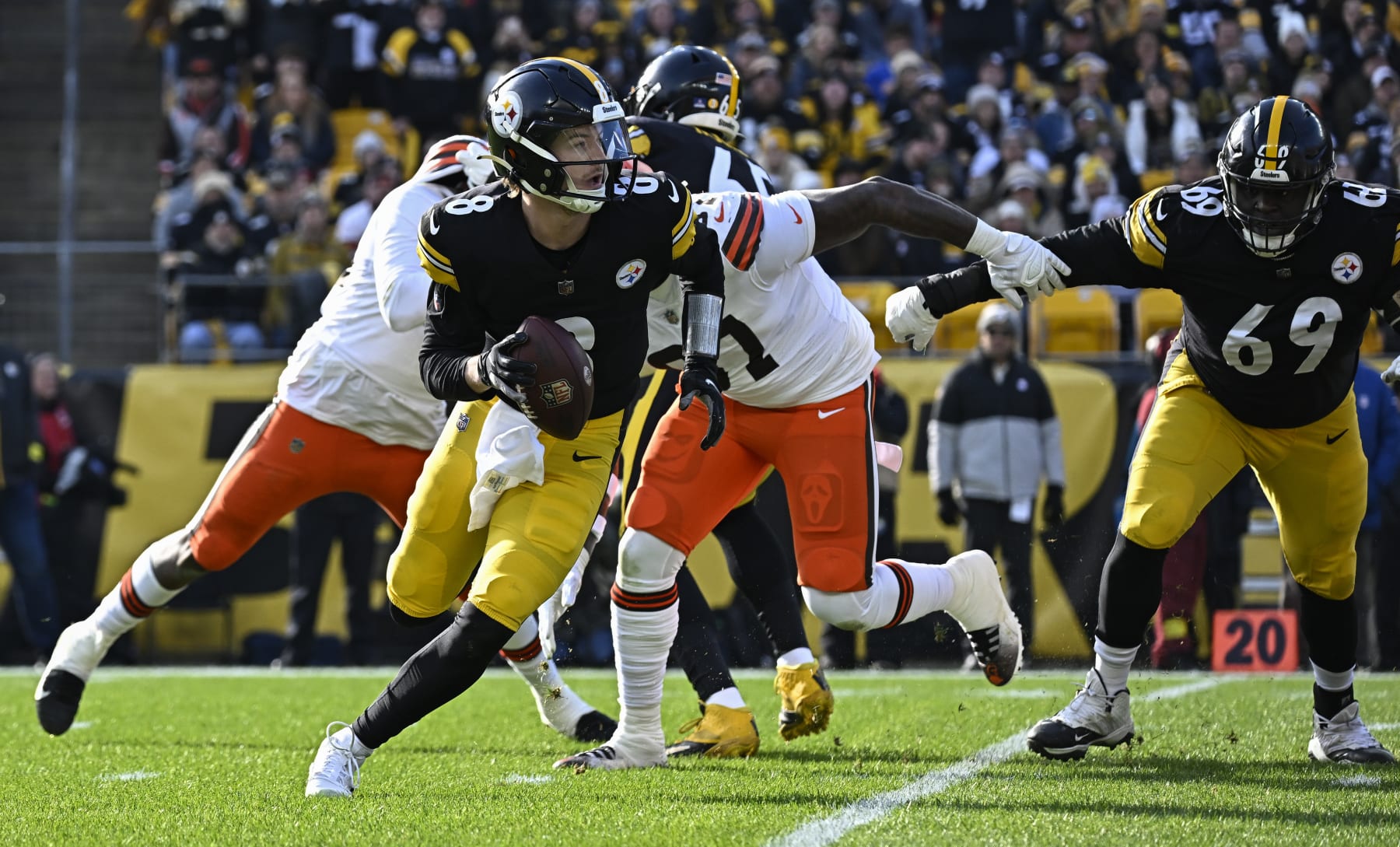PITTSBURGH, PA - JANUARY 08:   Pittsburgh Steelers quarterback Kenny Pickett (8) avoids a tackle then looks for a receiver during the game between the Pittsburgh Steelers and the Cleveland Browns at Acrisure Stadium on January 8, 2023 in Pittsburgh, PA. (Photo by Shelley Lipton/Icon Sportswire via Getty Images)