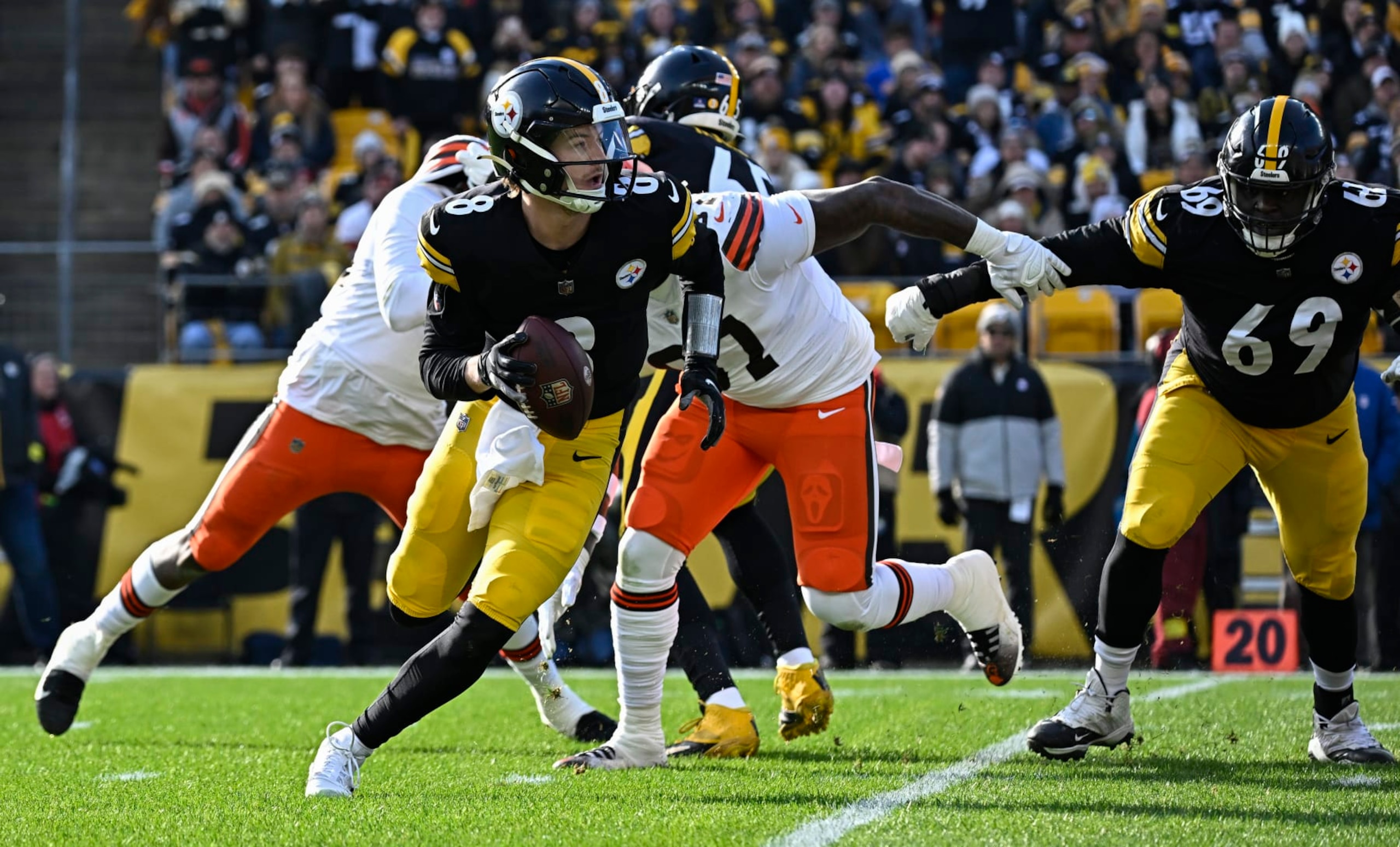 PITTSBURGH, PA - JANUARY 08:   Pittsburgh Steelers quarterback Kenny Pickett (8) avoids a tackle then looks for a receiver during the game between the Pittsburgh Steelers and the Cleveland Browns at Acrisure Stadium on January 8, 2023 in Pittsburgh, PA. (Photo by Shelley Lipton/Icon Sportswire via Getty Images)