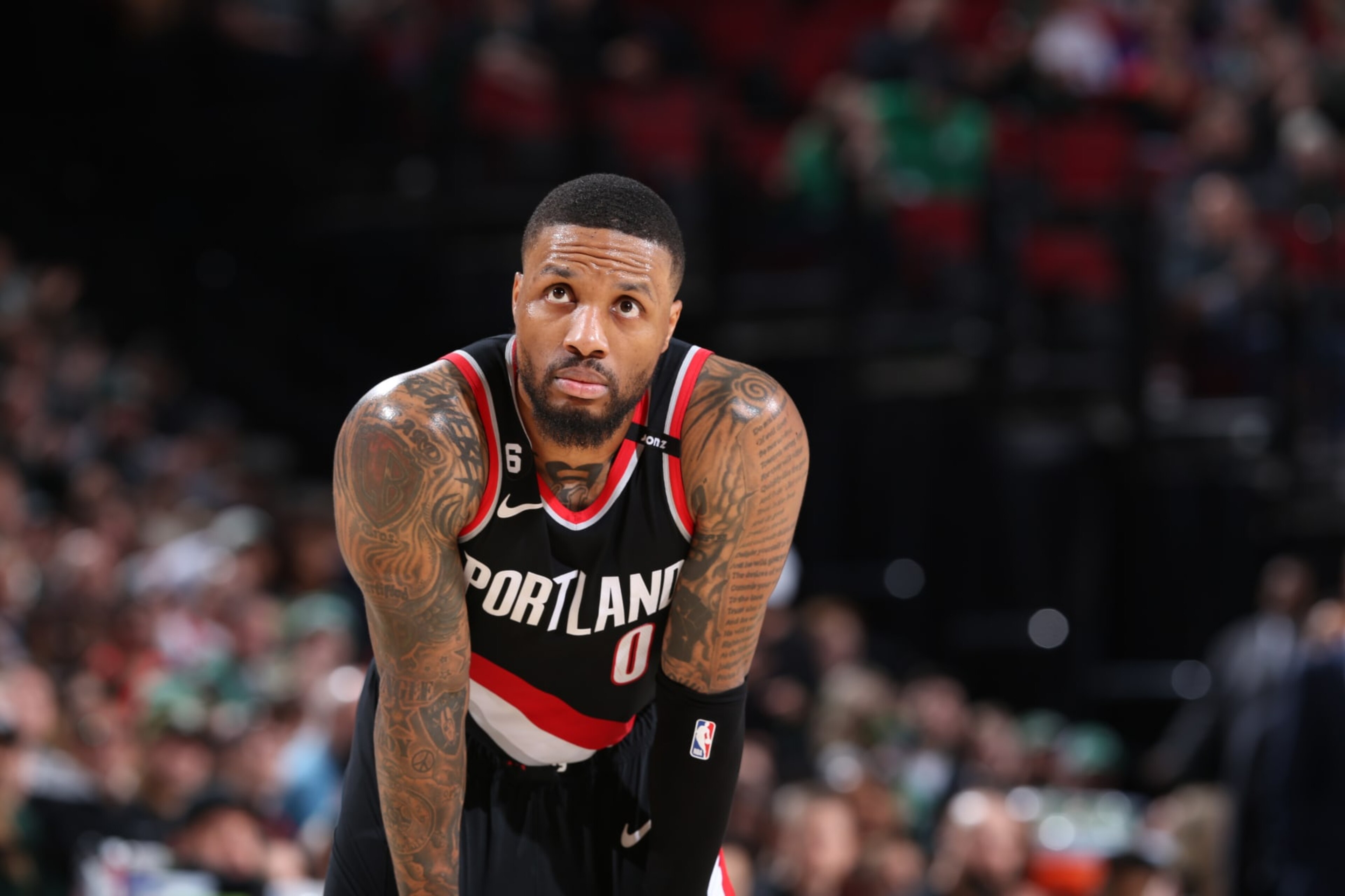 PORTLAND, OR - MARCH 17: Damian Lillard #0 of the Portland Trail Blazers looks on during the game against the Boston Celtics on March 17, 2023 at the Moda Center Arena in Portland, Oregon. NOTE TO USER: User expressly acknowledges and agrees that, by downloading and or using this photograph, user is consenting to the terms and conditions of the Getty Images License Agreement. Mandatory Copyright Notice: Copyright 2023 NBAE (Photo by Sam Forencich/NBAE via Getty Images) PORTLAND, OR - MARCH 17: Damian Lillard #0 of the Portland Trail Blazers looks on during the game against the Boston Celtics on March 17, 2023 at the Moda Center Arena in Portland, Oregon. NOTE TO USER: User expressly acknowledges and agrees that, by downloading and or using this photograph, user is consenting to the terms and conditions of the Getty Images License Agreement. Mandatory Copyright Notice: Copyright 2023 NBAE (Photo by Sam Forencich/NBAE via Getty Images)