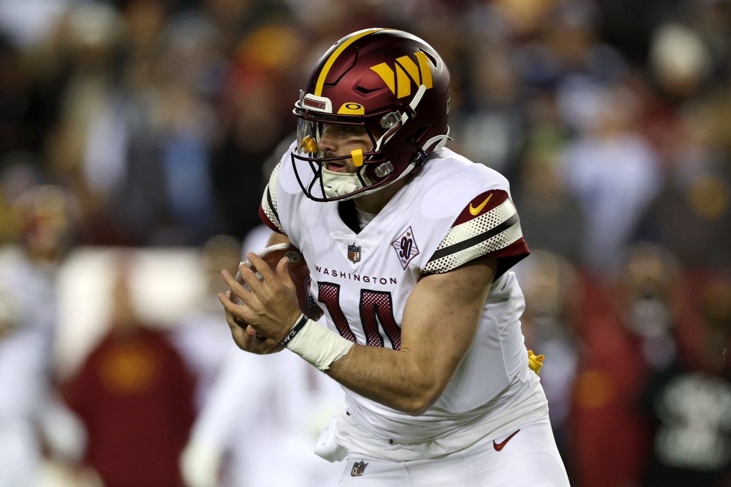 LANDOVER, MARYLAND - JANUARY 08: Quarterback Sam Howell #14 of the Washington Commanders runs with the ball against the Dallas Cowboys at FedExField on January 08, 2023 in Landover, Maryland. (Photo by Rob Carr/Getty Images)