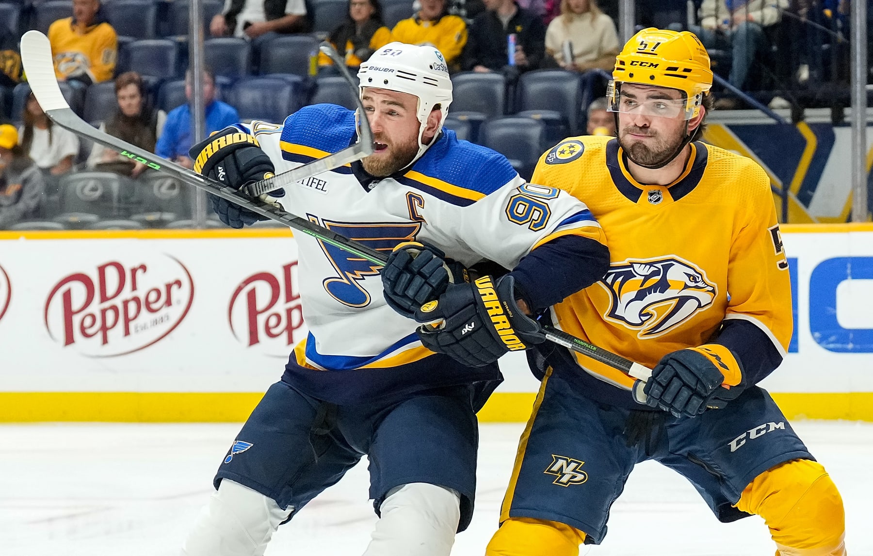 NASHVILLE, TENNESSEE - OCTOBER 27: Ryan O'Reilly #90 of the St. Louis Blues battles in front of the net against Dante Fabbro #57 of the Nashville Predators during an NHL game at Bridgestone Arena on October 27, 2022 in Nashville, Tennessee. (Photo by John Russell/NHLI via Getty Images)