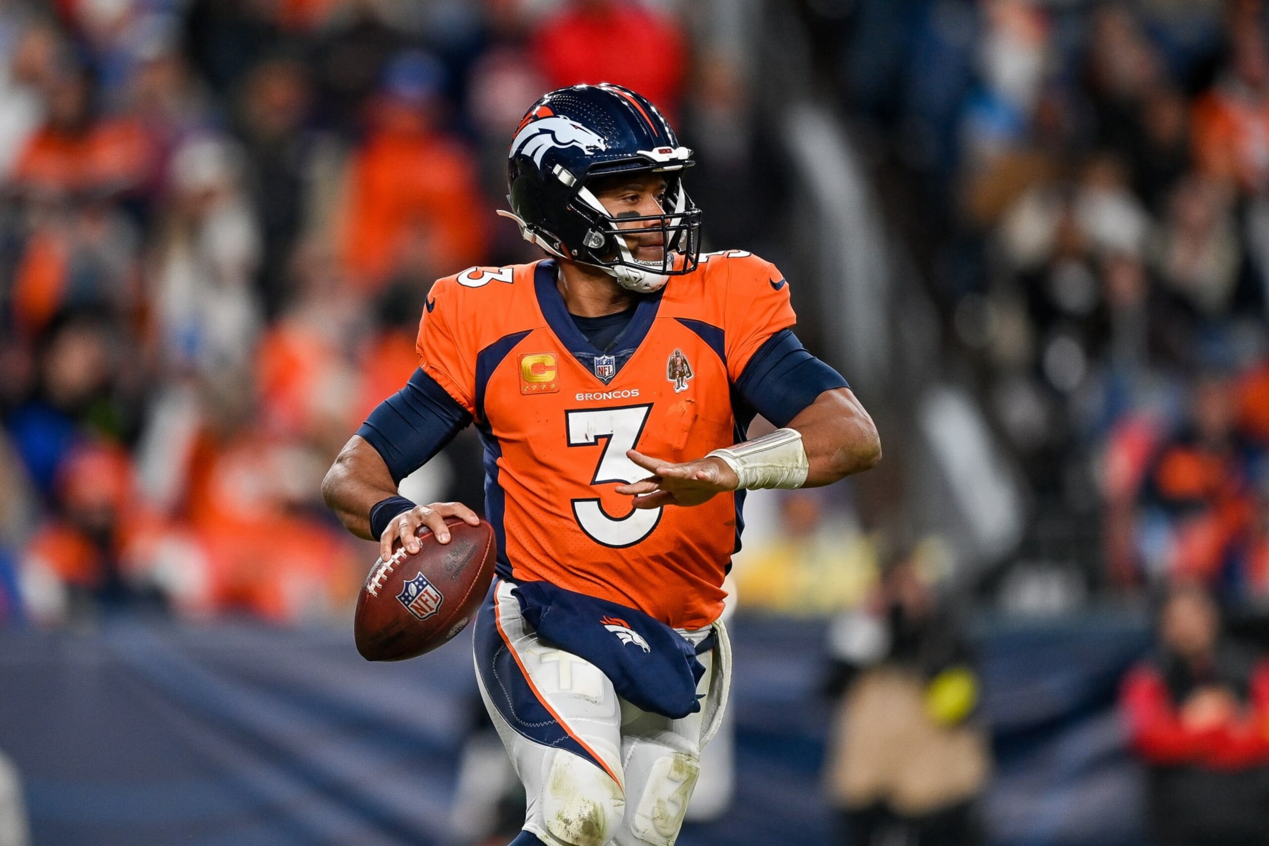 DENVER, CO - JANUARY 8: Denver Broncos quarterback Russell Wilson (3) rolls out of the pocket during a game between the Los Angeles Chargers and the Denver Broncos at Empower Field at Mile High on January 8, 2023 in Denver, Colorado. (Photo by Dustin Bradford/Icon Sportswire via Getty Images)