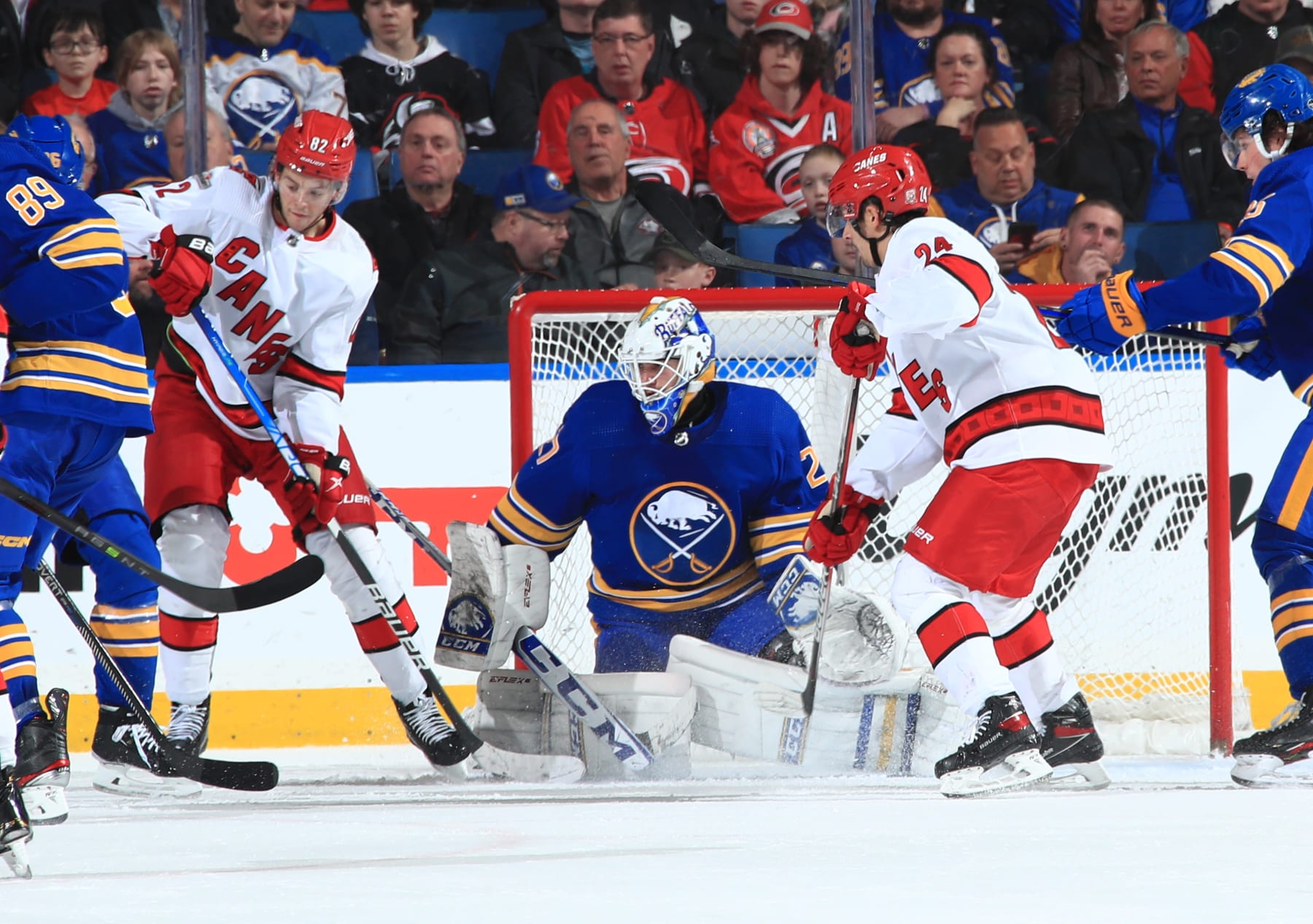 BUFFALO, NY - APRIL 8: Devon Levi #27 of the Buffalo Sabres tends goal against Jesperi Kotkaniemi #82 and Seth Jarvis #24 of the Carolina Hurricanes during an NHL game on April 8, 2023 at KeyBank Center in Buffalo, New York. (Buffalo won, 4-3. Photo by Bill Wippert/NHLI via Getty Images)