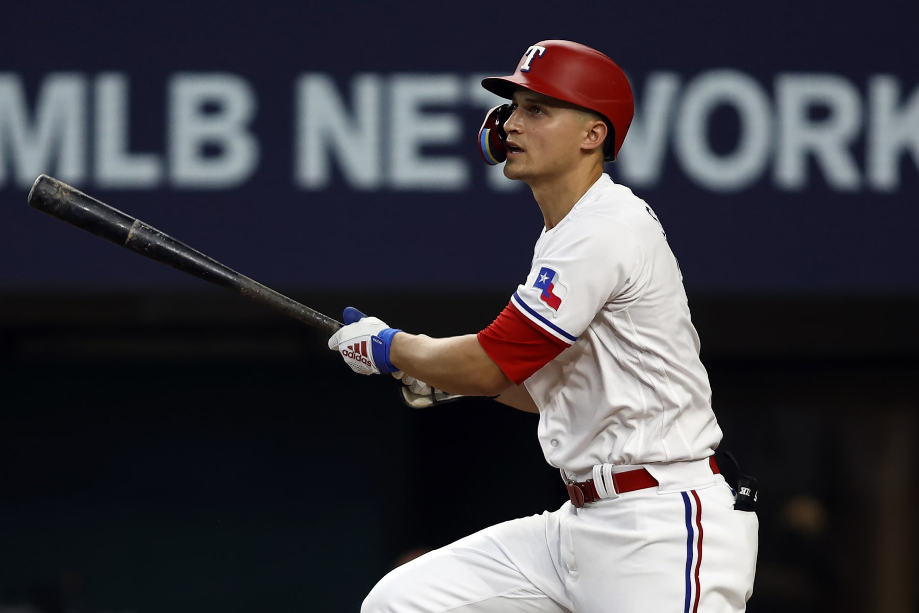ARLINGTON, TEXAS - JULY 03: Corey Seager #5 of the Texas Rangers hits a sacrifice fly to drive in a run against the Houston Astros in the eighth inning at Globe Life Field on July 03, 2023 in Arlington, Texas. (Photo by Tim Heitman/Getty Images)