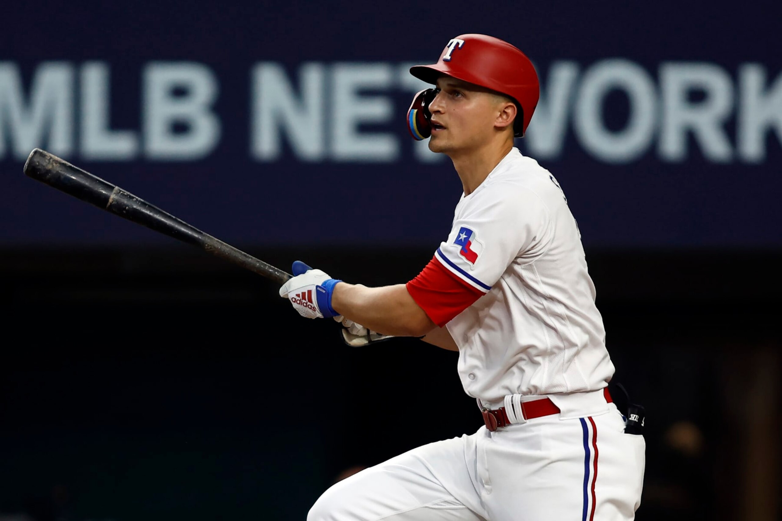 ARLINGTON, TEXAS - JULY 03: Corey Seager #5 of the Texas Rangers hits a sacrifice fly to drive in a run against the Houston Astros in the eighth inning at Globe Life Field on July 03, 2023 in Arlington, Texas. (Photo by Tim Heitman/Getty Images)