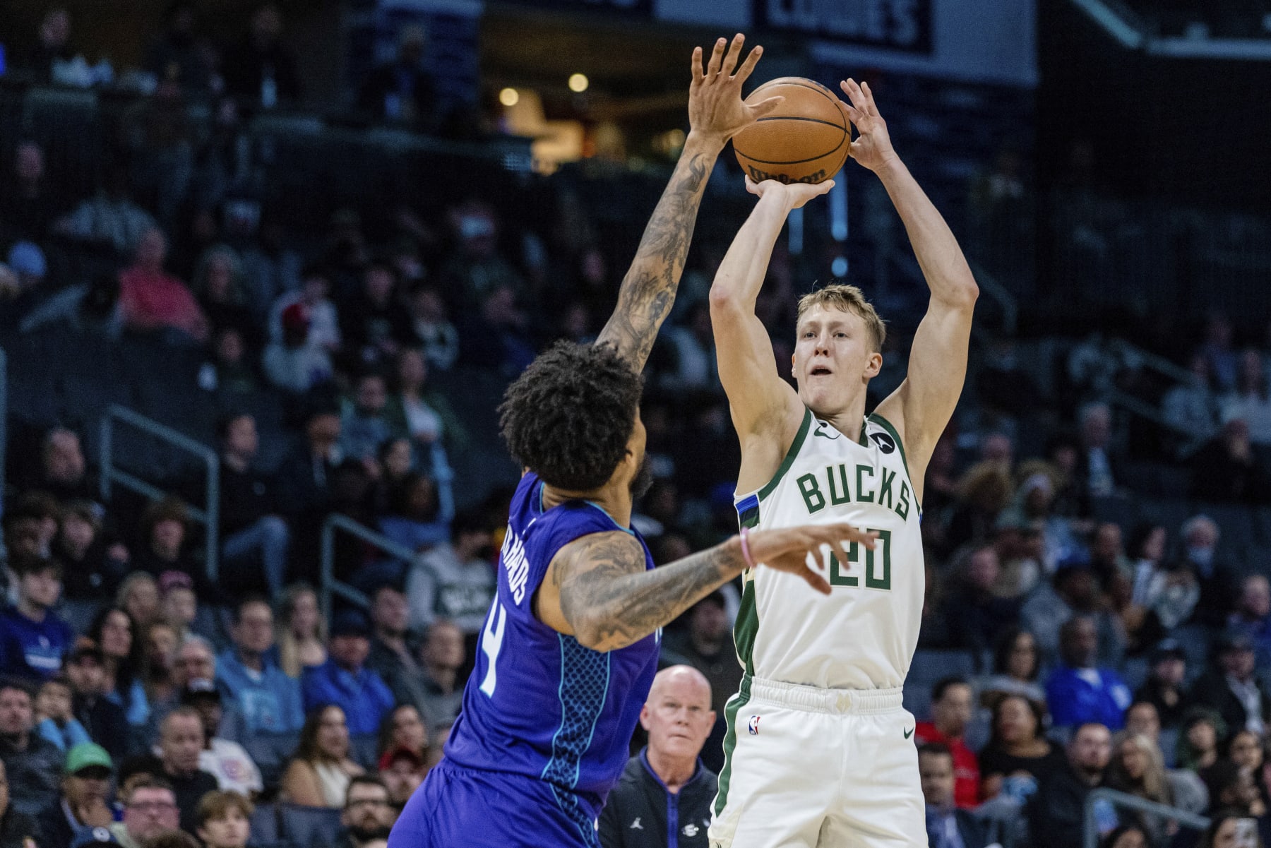 Charlotte Hornets center Nick Richards (4) guards the shot from Milwaukee Bucks guard AJ Green (20) during the first half of an NBA basketball game on Monday, Dec. 19, 2022, in Charlotte, N.C. (AP Photo/Scott Kinser)