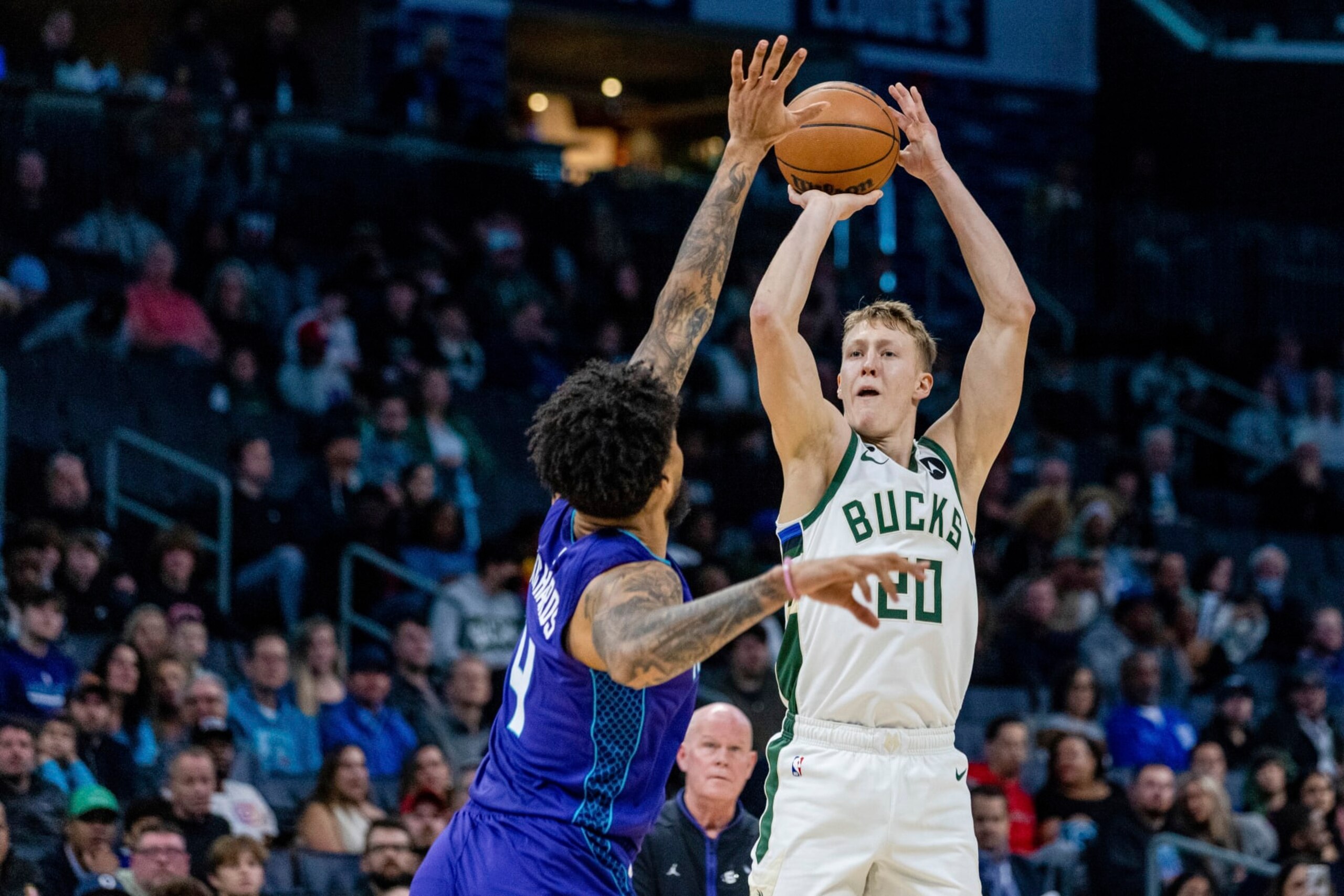 Charlotte Hornets center Nick Richards (4) guards the shot from Milwaukee Bucks guard AJ Green (20) during the first half of an NBA basketball game on Monday, Dec. 19, 2022, in Charlotte, N.C. (AP Photo/Scott Kinser)