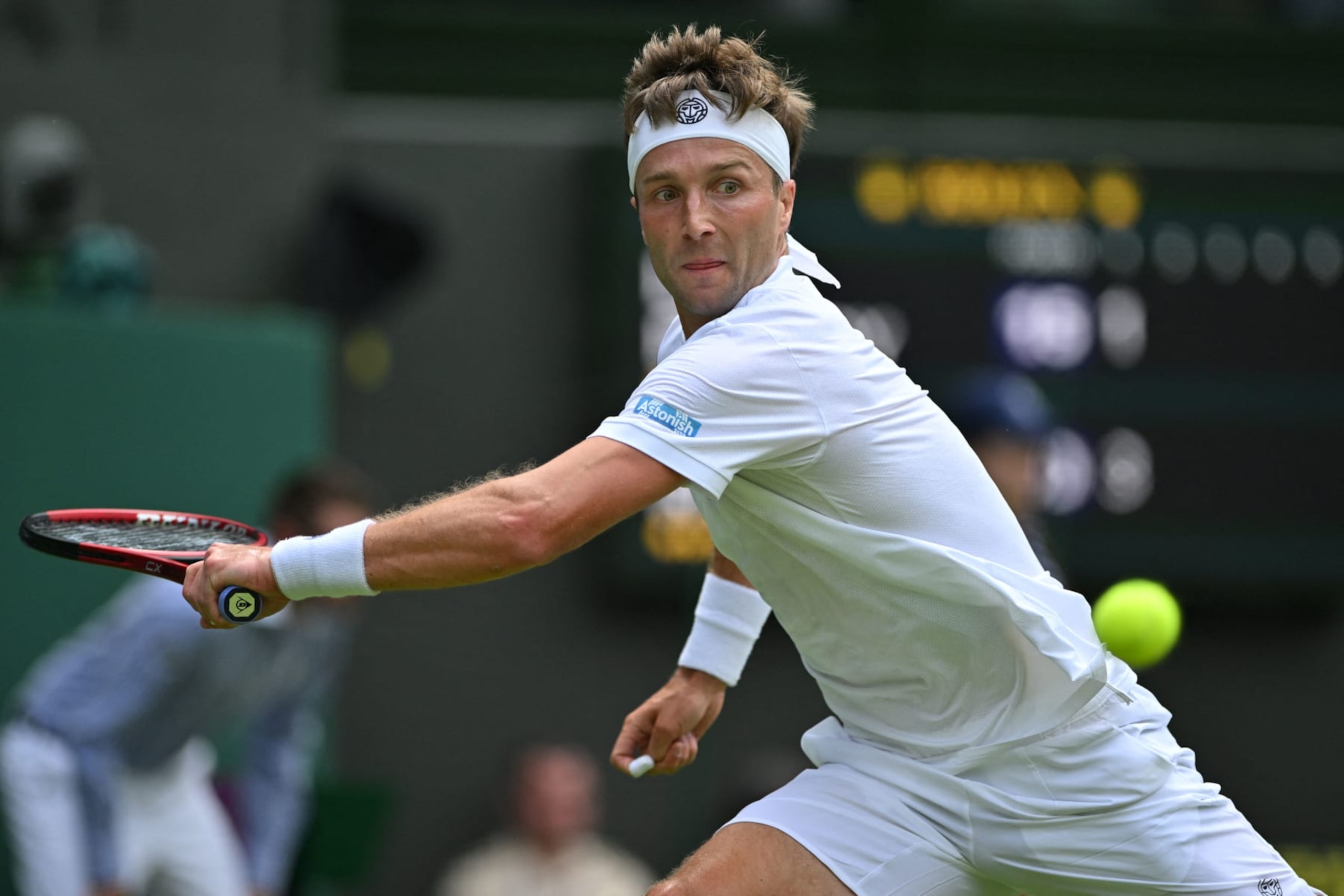 Britain's Liam Broady returns the ball to Norway's Casper Ruud during their men's singles tennis match on the fourth day of the 2023 Wimbledon Championships at The All England Tennis Club in Wimbledon, southwest London, on July 6, 2023. (Photo by Glyn KIRK / AFP) / RESTRICTED TO EDITORIAL USE (Photo by GLYN KIRK/AFP via Getty Images)