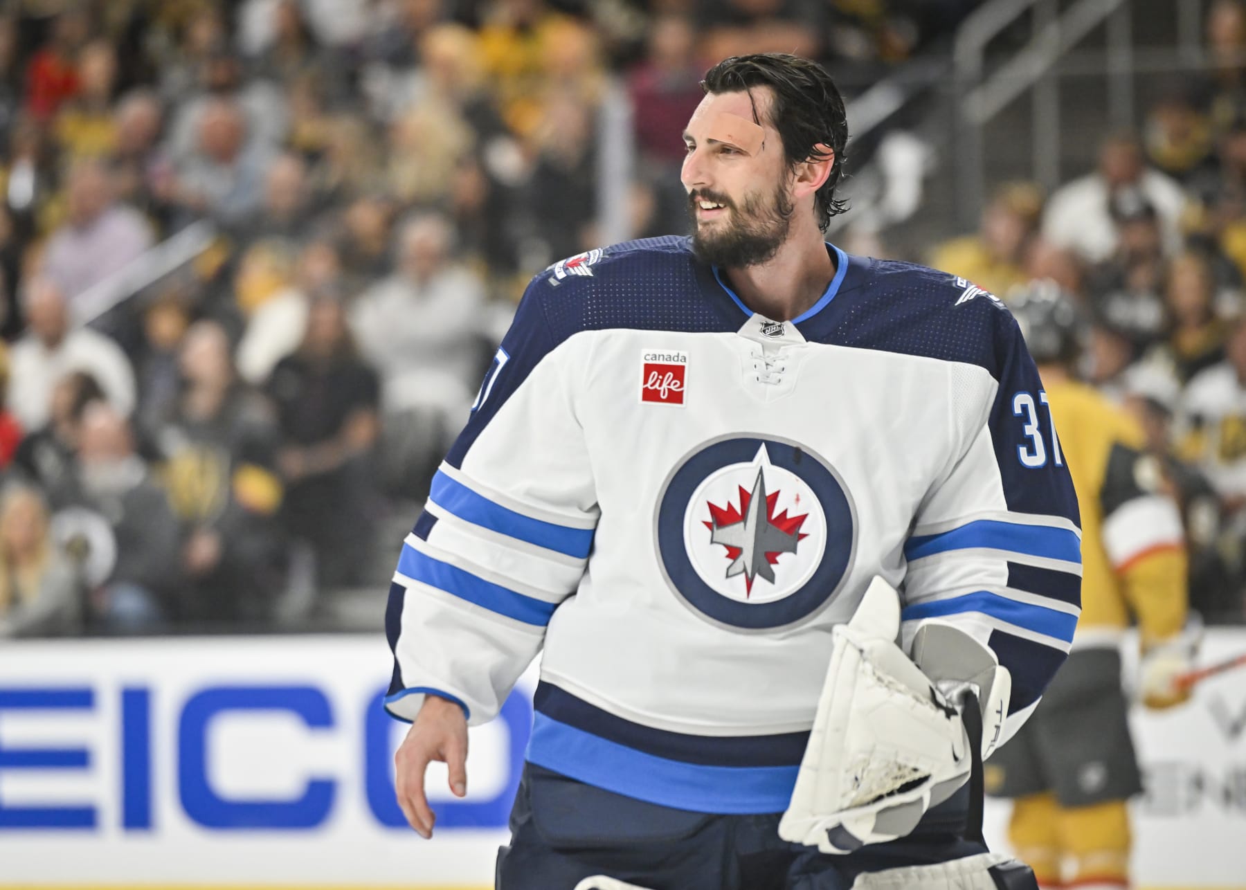 LAS VEGAS, NEVADA - APRIL 20: Connor Hellebuyck #37 of the Winnipeg Jets reacts after suffering a cut on a shot by Jack Eichel #9 of the Vegas Golden Knights during the first period in Game Two of the First Round of the 2023 Stanley Cup Playoffs at T-Mobile Arena on April 20, 2023 in Las Vegas, Nevada. (Photo by David Becker/NHLI via Getty Images)