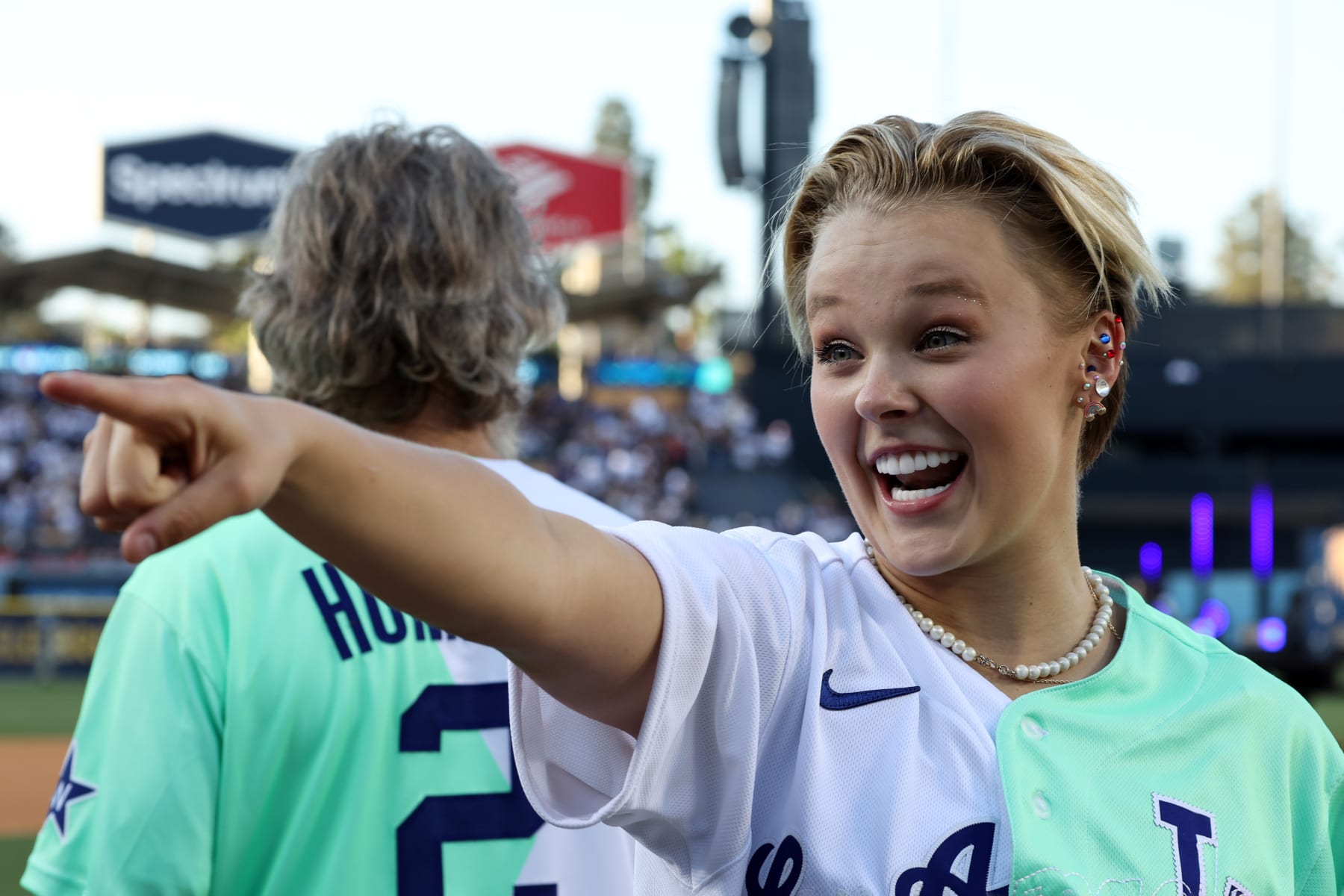 LOS ANGELES, CA - JULY 16:  Pop star JoJo Siwa reacts prior to the MGM All-Star Celebrity Softball Game at Dodger Stadium on Saturday, July 16, 2022 in Los Angeles, California. (Photo by Mary DeCicco/MLB Photos via Getty Images)