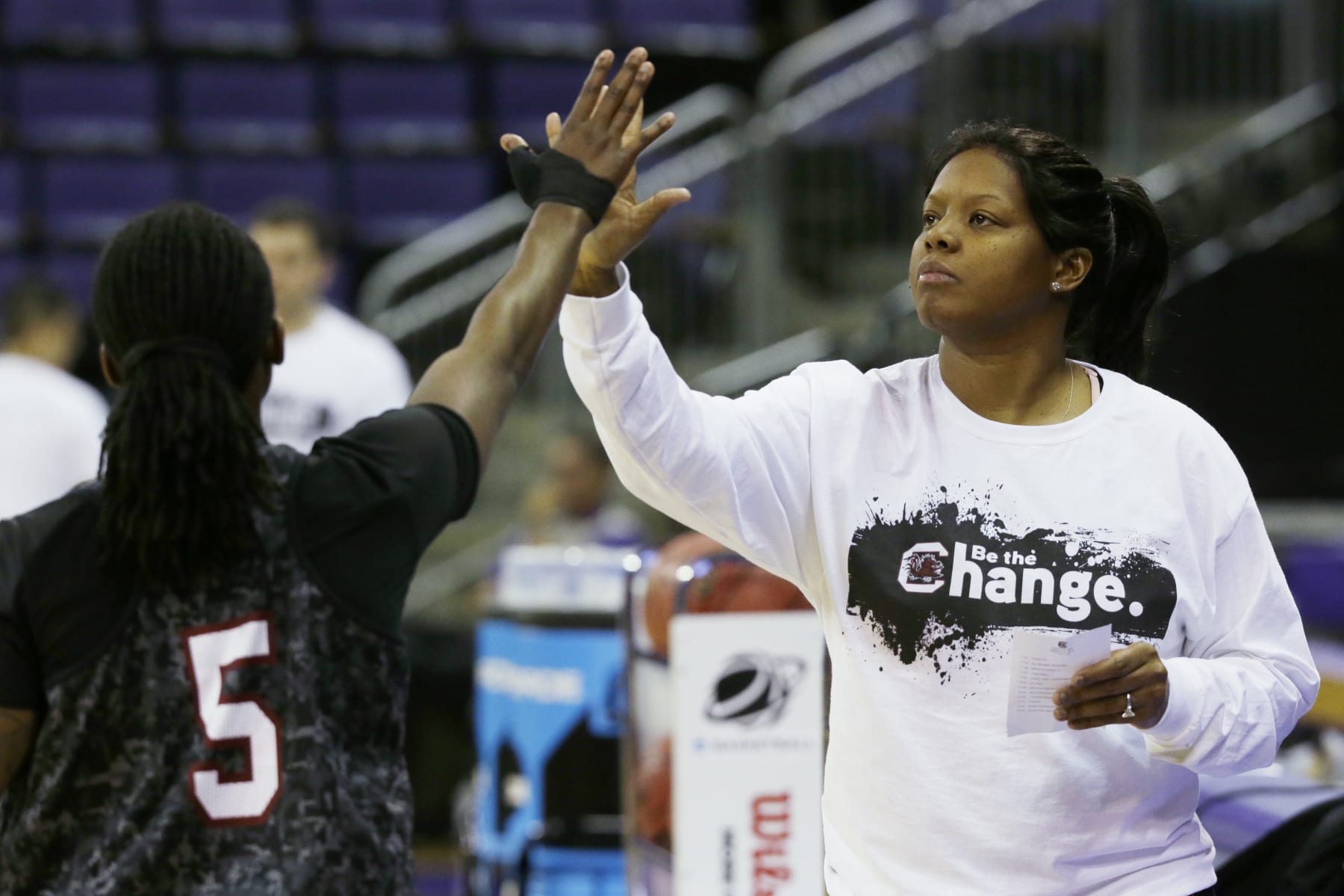 FILE - South Carolina assistant coach Nikki McCray high-fives South Carolina guard Khadijah Sessions (5) during practice at the NCAA women's college basketball tournament, Saturday, March 22, 2014, in Seattle. Two-time Olympic gold medalist and former ABL MVP Nikki McCray-Penson has died. She was 51. McCray-Penson was an assistant women's basketball coach at Rutgers last season and the school confirmed her death, although the cause of her passing was not immediately known. (AP Photo/Ted S. Warren, File)