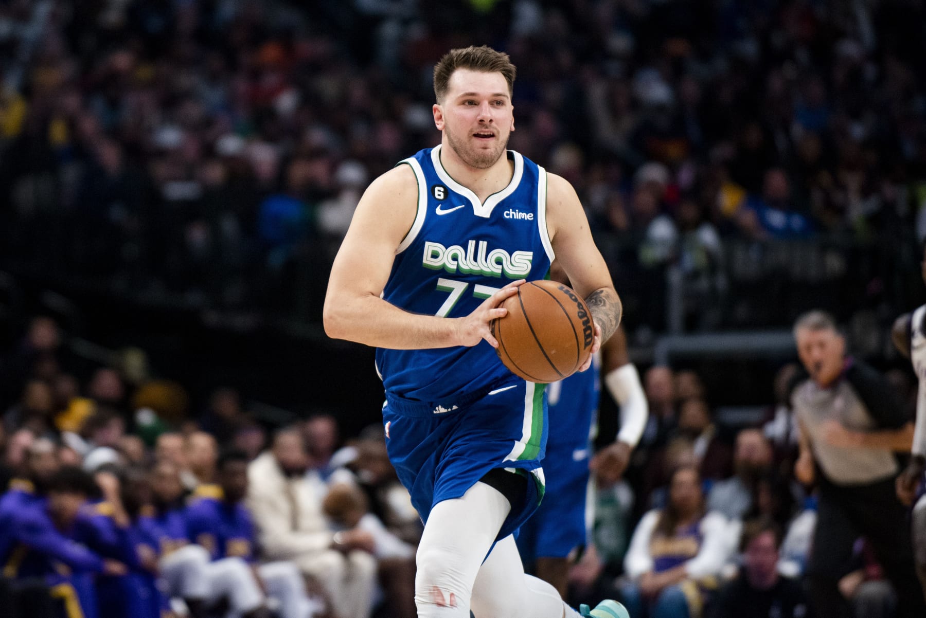 Dallas Mavericks guard Luka Doncic (77) prepares to pass the ball to a teammate in the second half of an NBA basketball game against the Los Angeles Lakers in Dallas, Sunday, Dec. 25, 2022. (AP Photo/Emil T. Lippe)