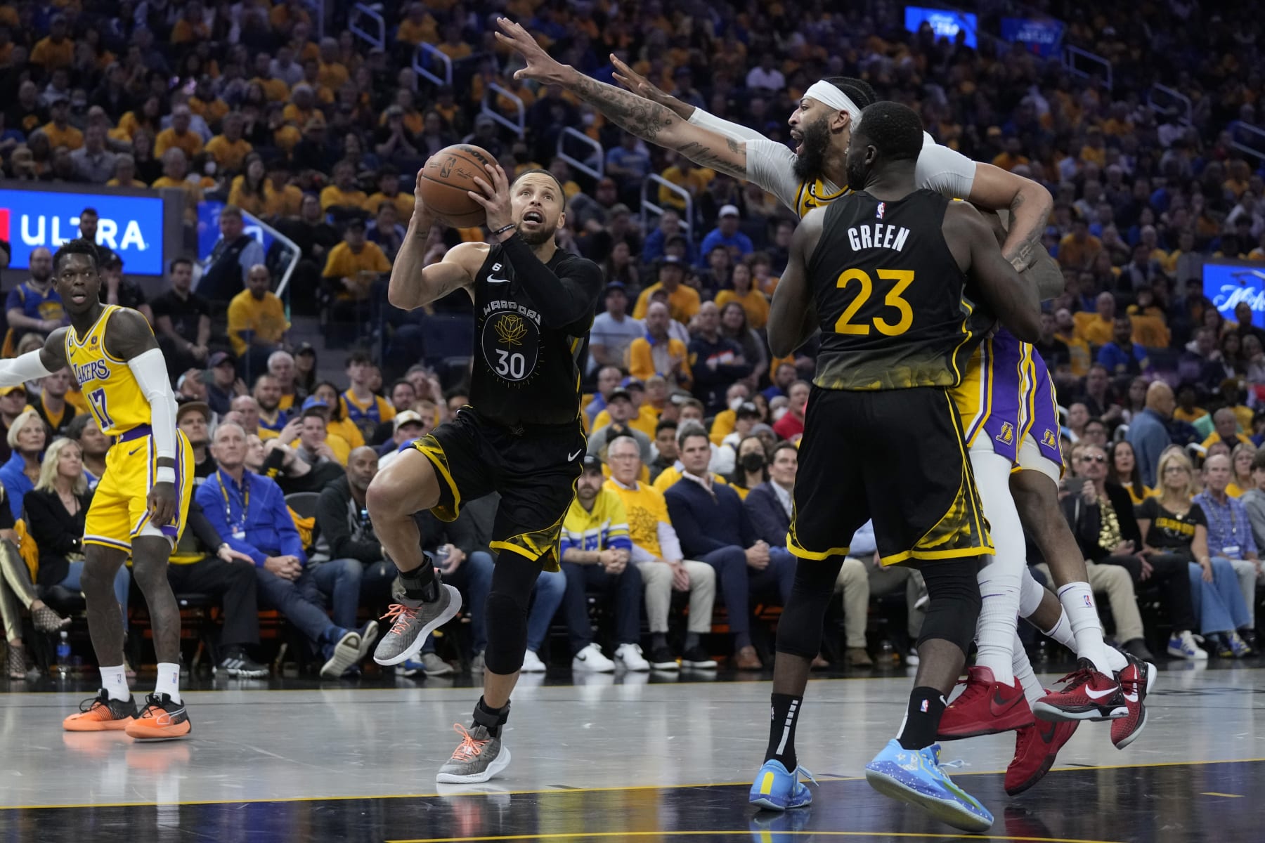Golden State Warriors guard Stephen Curry (30) goes up for a shot while defended by Los Angeles Lakers forward Anthony Davis, right, during the second half of an NBA basketball Western Conference semifinal game, Tuesday, May 2, 2023, in San Francisco. (AP Photo/Jeff Chiu)