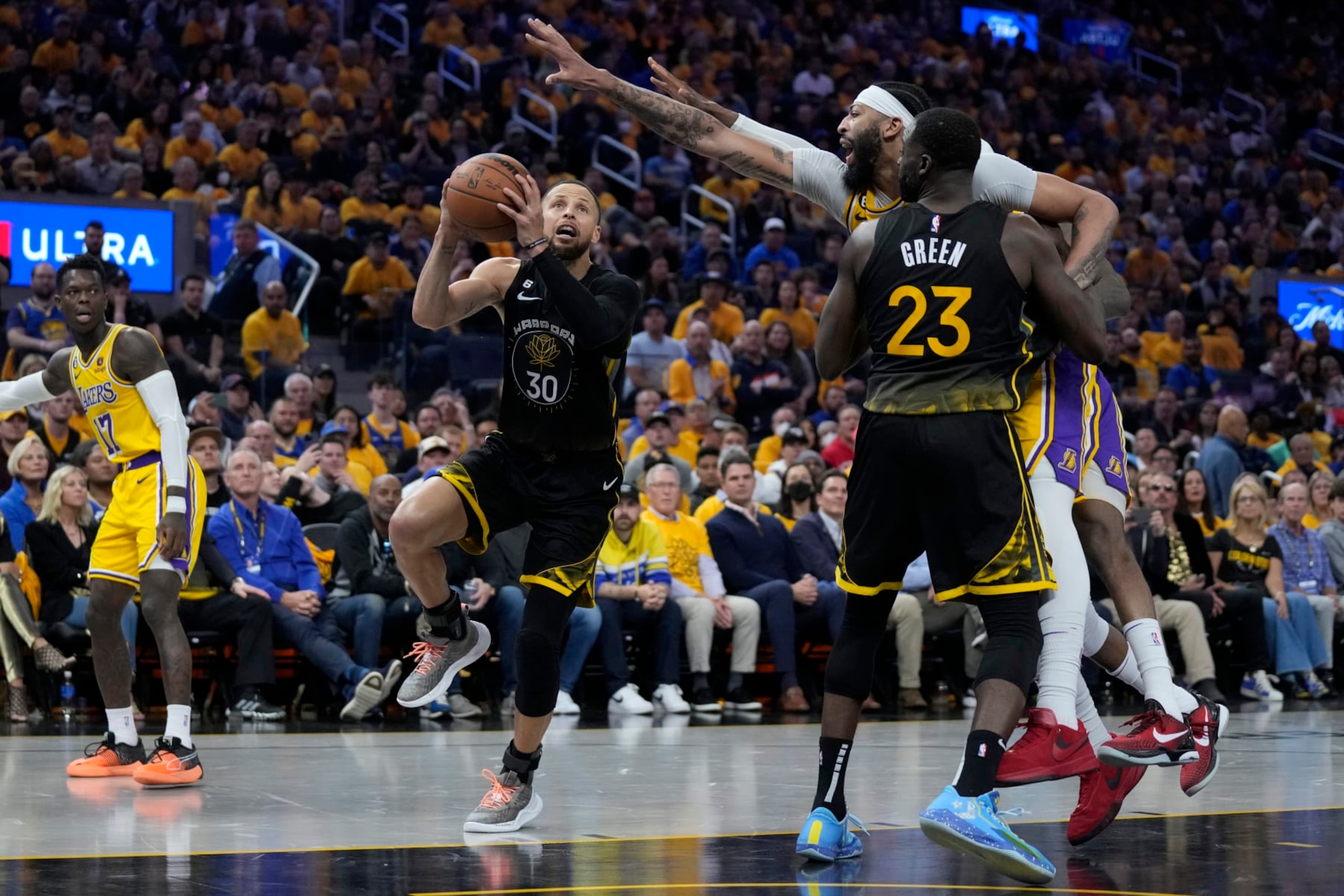 Golden State Warriors guard Stephen Curry (30) goes up for a shot while defended by Los Angeles Lakers forward Anthony Davis, right, during the second half of an NBA basketball Western Conference semifinal game, Tuesday, May 2, 2023, in San Francisco. (AP Photo/Jeff Chiu)