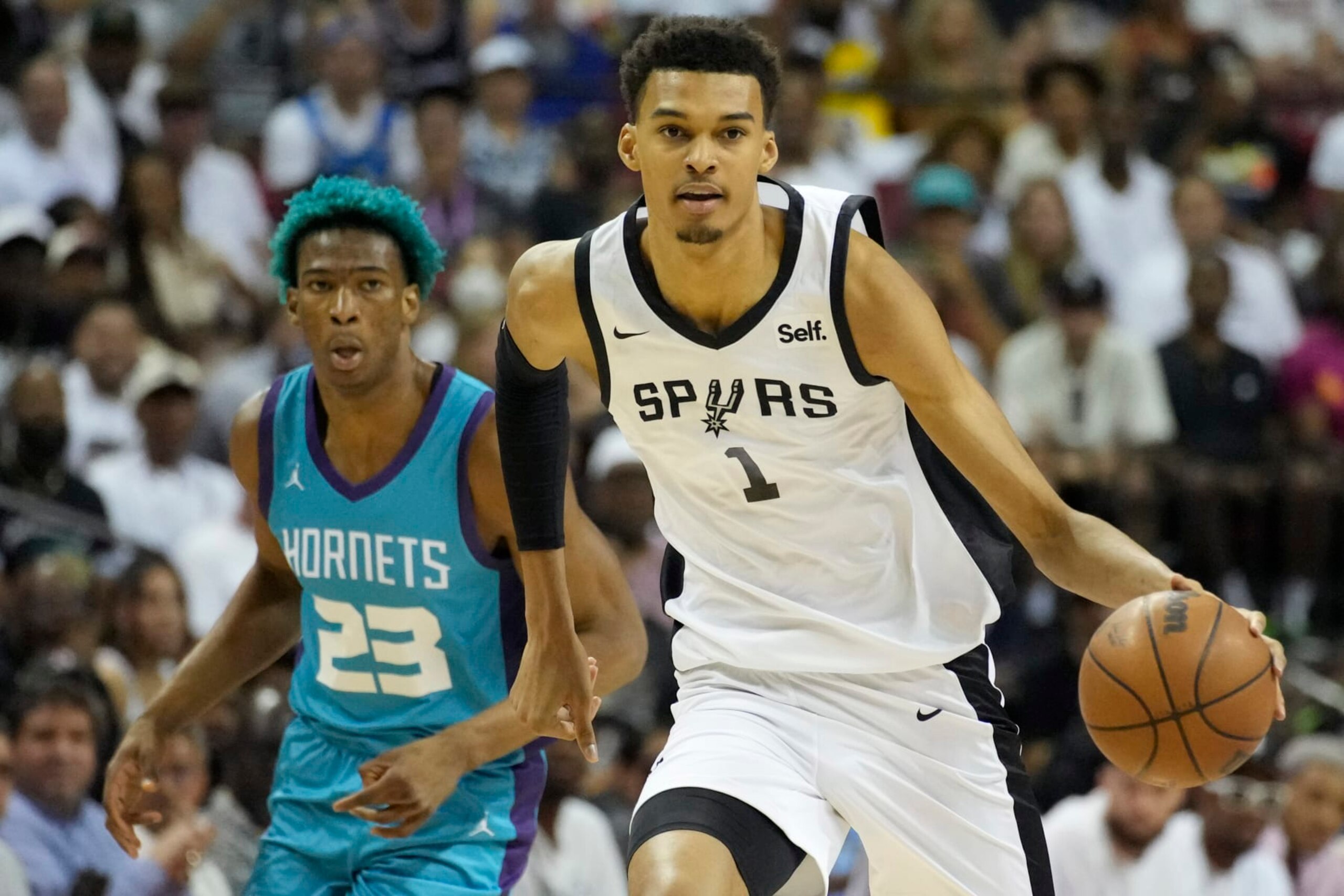 San Antonio Spurs' Victor Wembanyama drives against the Charlotte Hornets during the first half of an NBA summer league basketball game Friday, July 7, 2023, in Las Vegas. (AP Photo/John Locher)