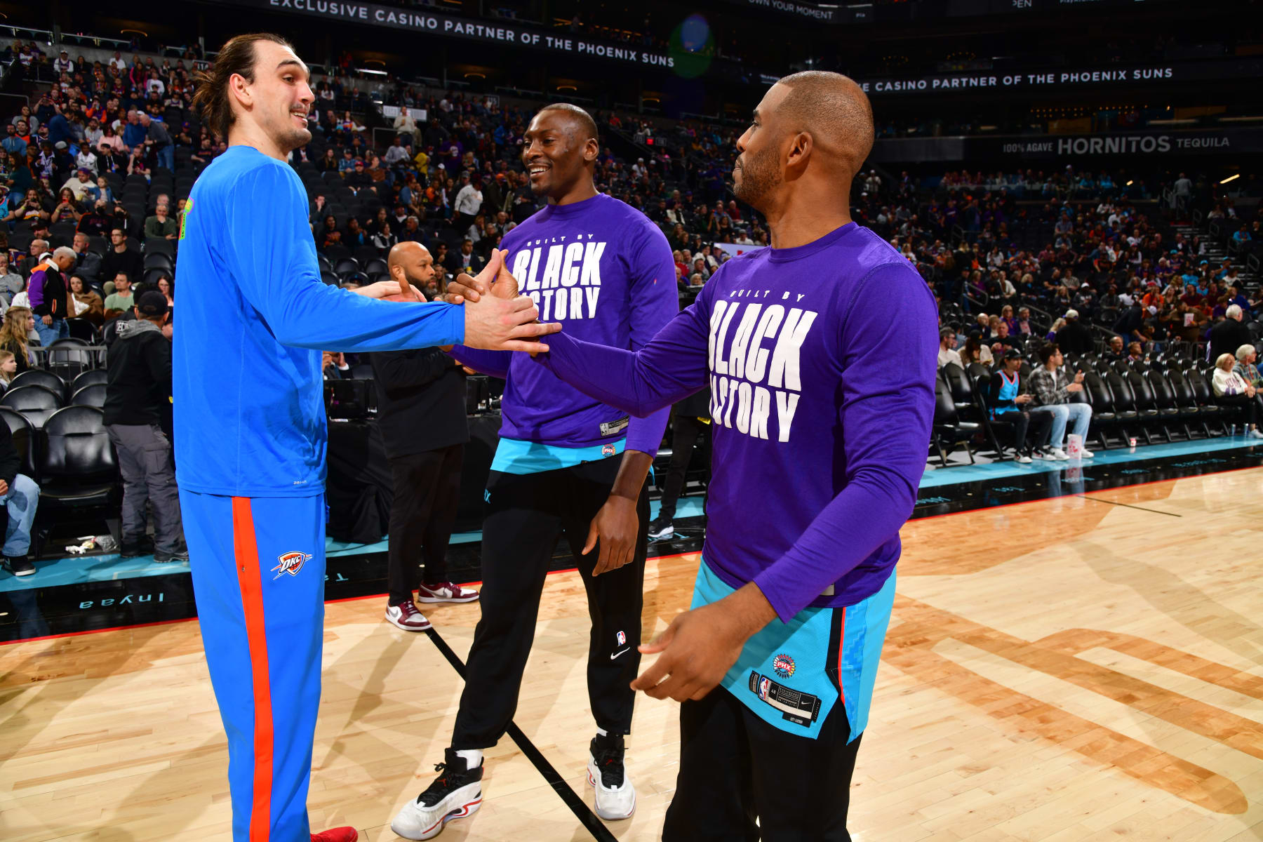 PHOENIX, AZ - FEBRUARY 24: Dario Saric #9 of the Oklahoma City Thunder talks with former teammates Chris Paul #3 and Bismack Biyombo #18 of the Phoenix Suns before the game on February 24, 2023 at Footprint Center in Phoenix, Arizona. NOTE TO USER: User expressly acknowledges and agrees that, by downloading and or using this photograph, user is consenting to the terms and conditions of the Getty Images License Agreement. Mandatory Copyright Notice: Copyright 2023 NBAE (Photo by Barry Gossage/NBAE via Getty Images)