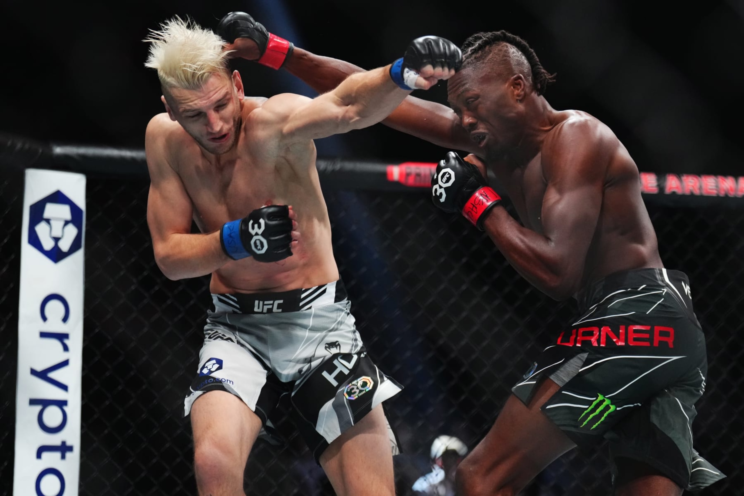 LAS VEGAS, NEVADA - JULY 08: (L-R) Dan Hooker of New Zealand trades punches with Jalin Turner in a lightweight fight during the UFC 290 event at T-Mobile Arena on July 08, 2023 in Las Vegas, Nevada. (Photo by Chris Unger/Zuffa LLC via Getty Images)