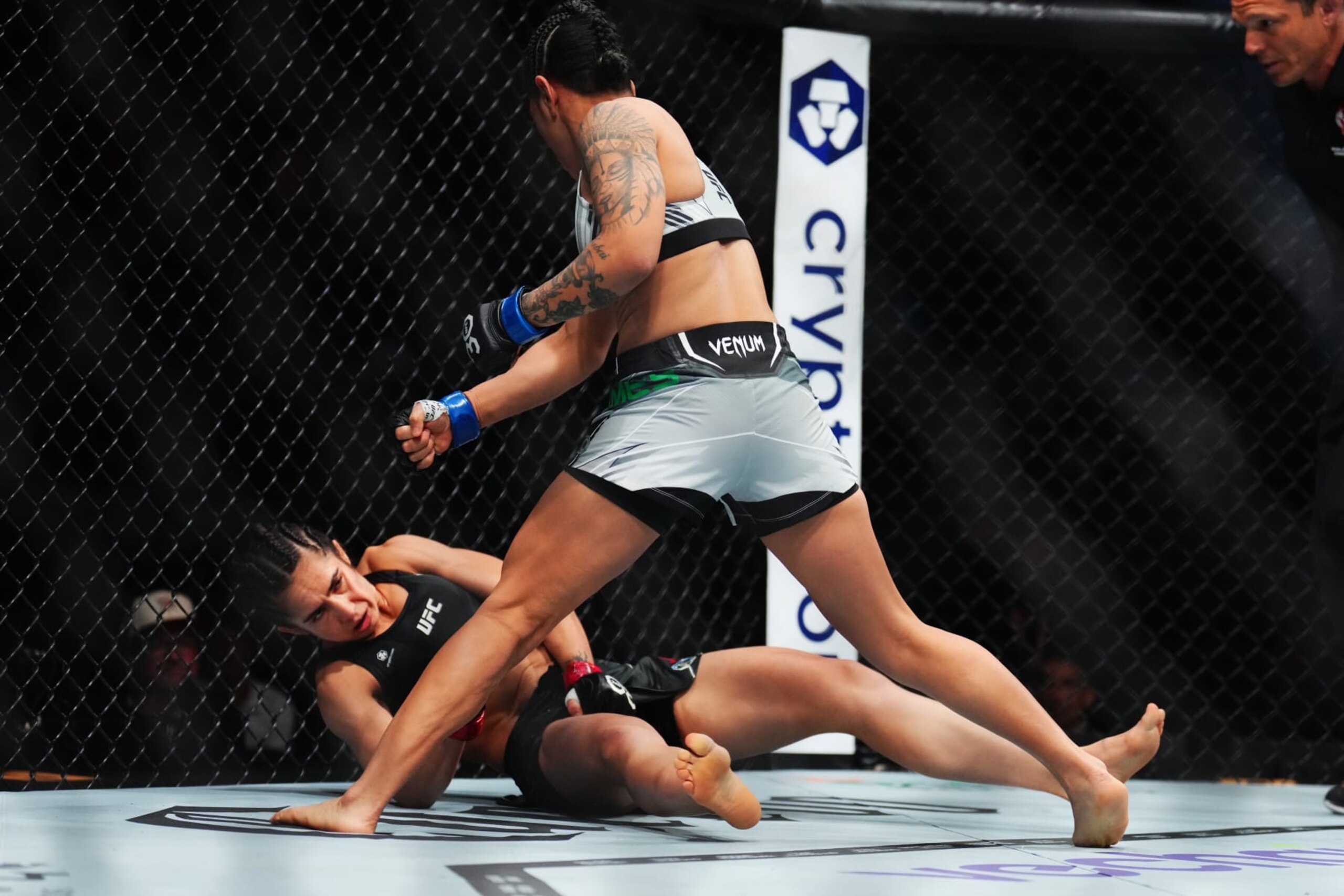 LAS VEGAS, NEVADA - JULY 08: (R-L) Denise Gomes of Brazil knocks down Yazmin Jauregui of Mexico in a strawweight fight during the UFC 290 event at T-Mobile Arena on July 08, 2023 in Las Vegas, Nevada. (Photo by Chris Unger/Zuffa LLC via Getty Images