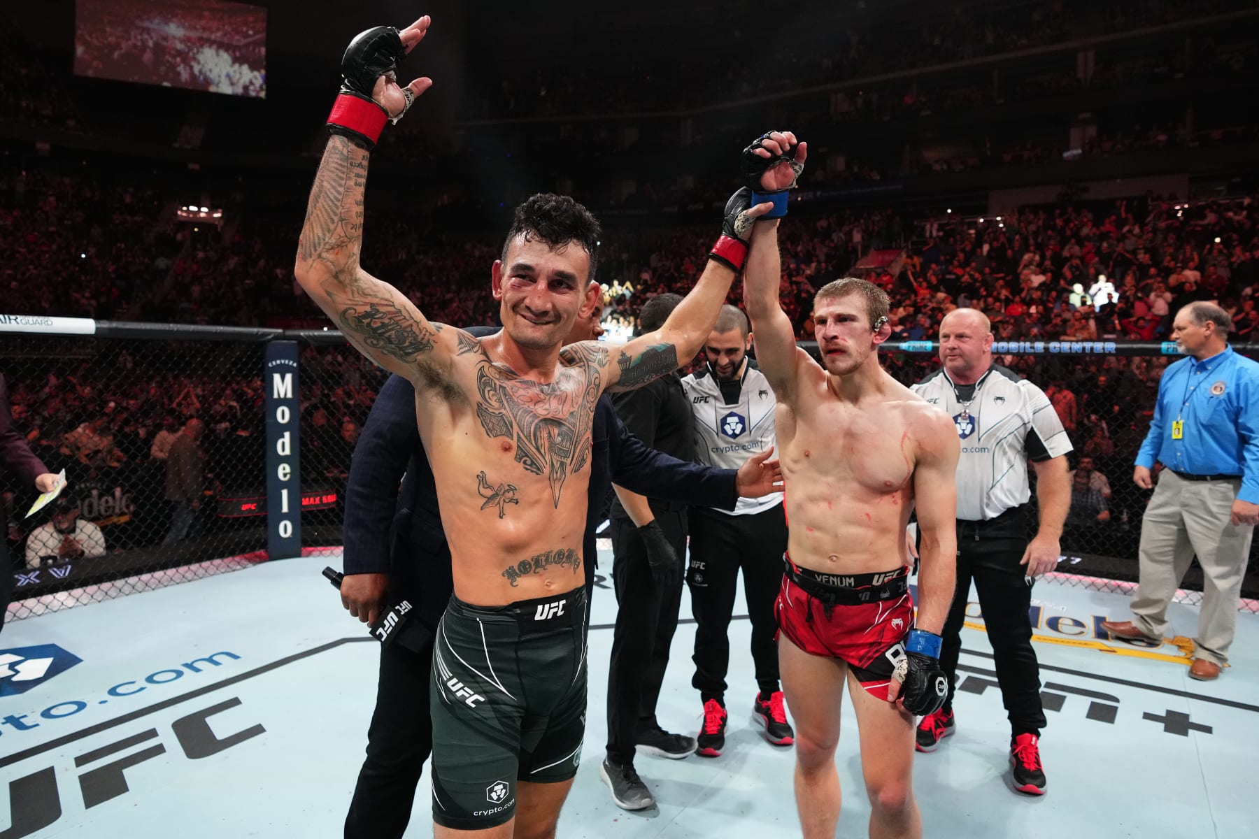 KANSAS CITY, MISSOURI - APRIL 15: (L-R) Max Holloway reacts after defeating Arnold Allen of England in a featherweight fight during the UFC Fight Night event at T-Mobile Center on April 15, 2023 in Kansas City, Missouri. (Photo by Josh Hedges/Zuffa LLC via Getty Images)