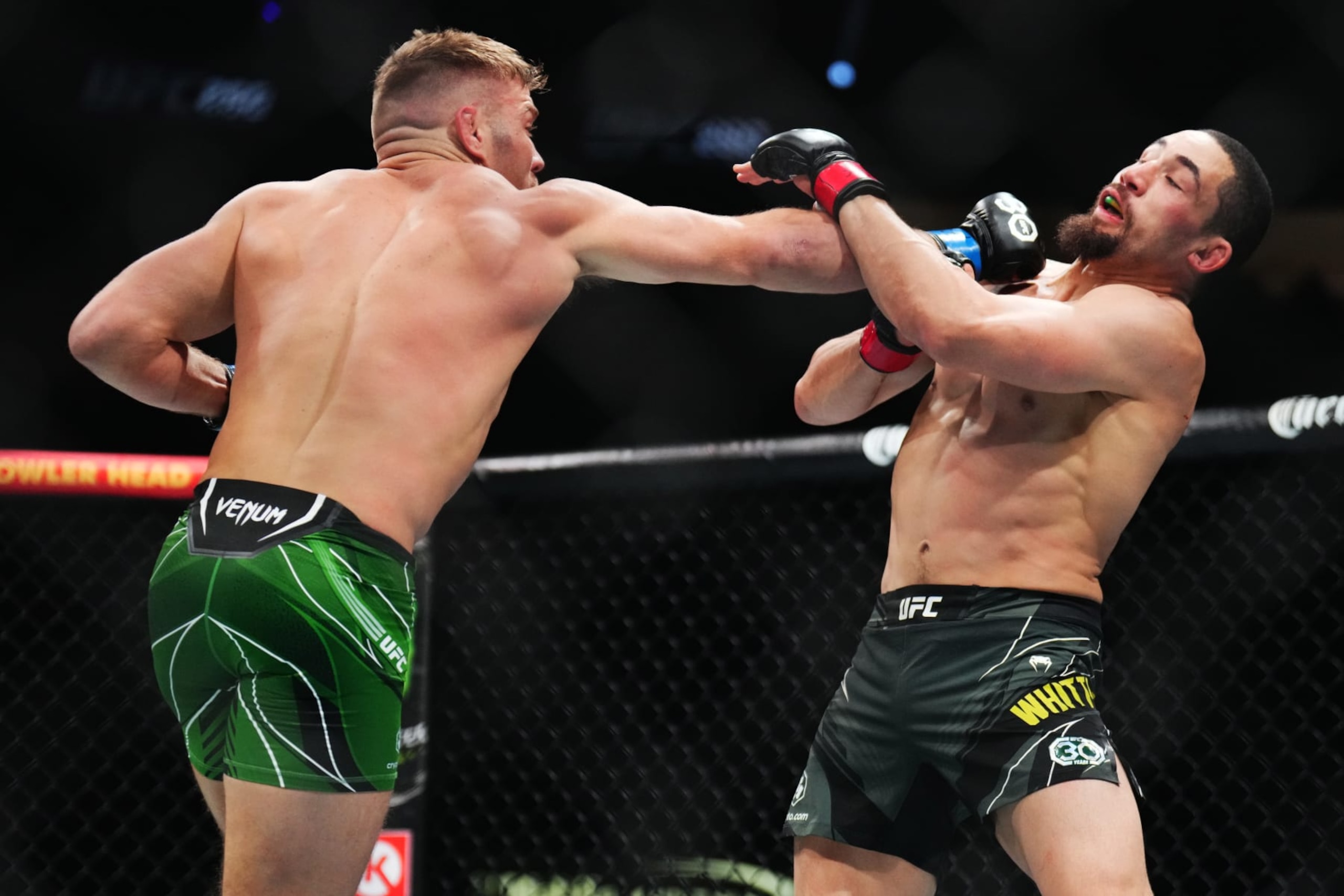 LAS VEGAS, NEVADA - JULY 08: (L-R) Dricus Du Plessis of South Africa punches Robert Whittaker of New Zealand in a middleweight fight during the UFC 290 event at T-Mobile Arena on July 08, 2023 in Las Vegas, Nevada. (Photo by Chris Unger/Zuffa LLC via Getty Images)