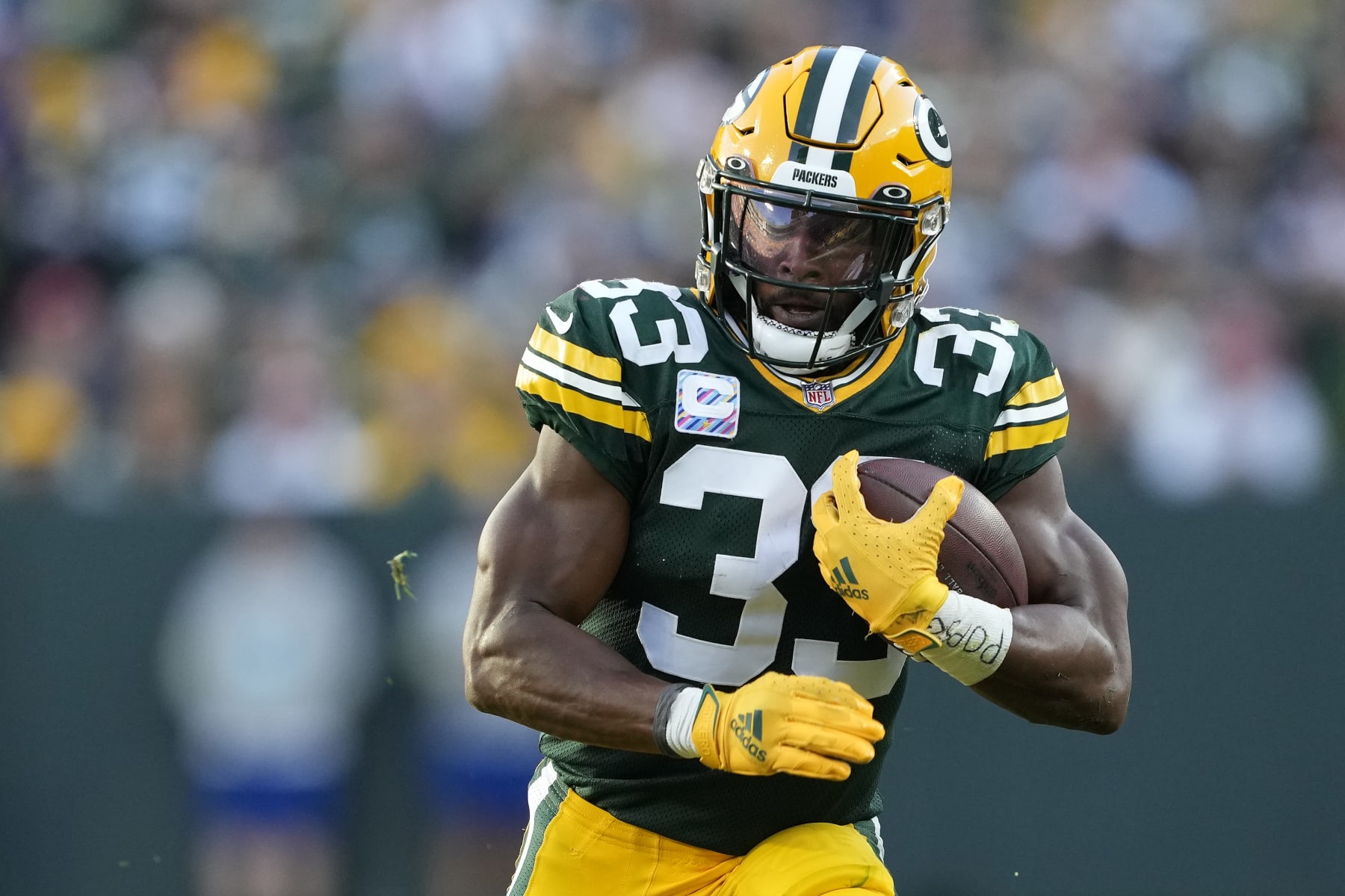 GREEN BAY, WISCONSIN - OCTOBER 02: Aaron Jones #33 of the Green Bay Packers runs with the ball in the third quarter against the New England Patriots at Lambeau Field on October 02, 2022 in Green Bay, Wisconsin. (Photo by Patrick McDermott/Getty Images)