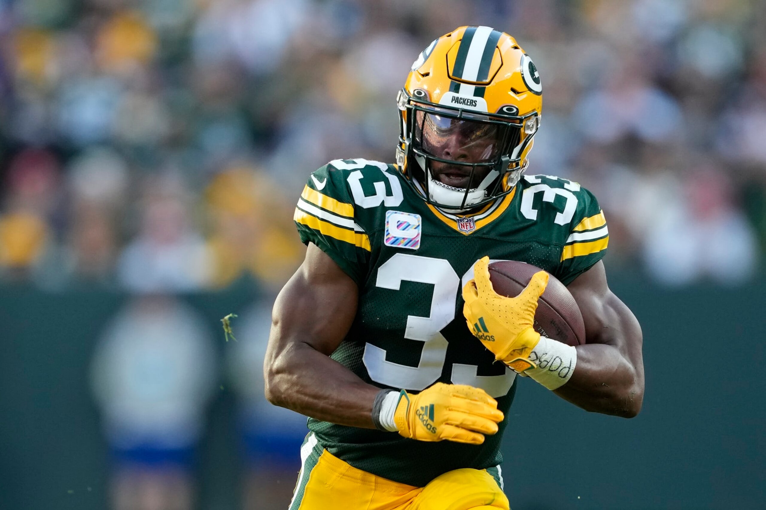 GREEN BAY, WISCONSIN - OCTOBER 02: Aaron Jones #33 of the Green Bay Packers runs with the ball in the third quarter against the New England Patriots at Lambeau Field on October 02, 2022 in Green Bay, Wisconsin. (Photo by Patrick McDermott/Getty Images)